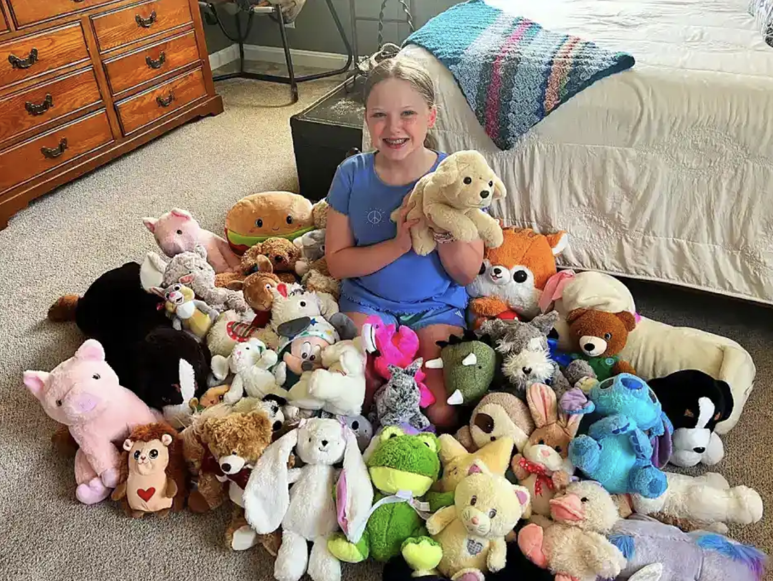 Sadie Hutson with the stuffies she rescued, repaired, and donated