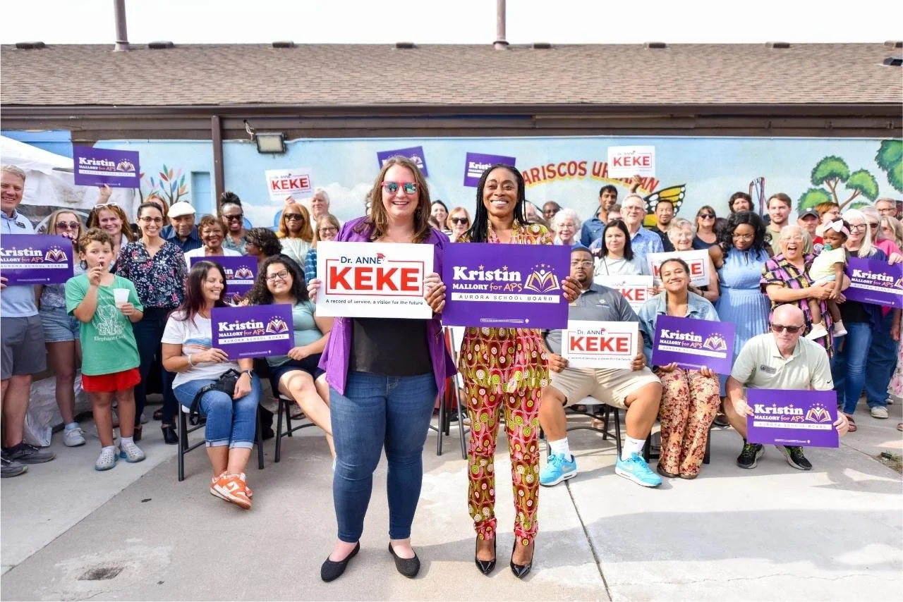 ann-and-kristin-holding-signs.jpg