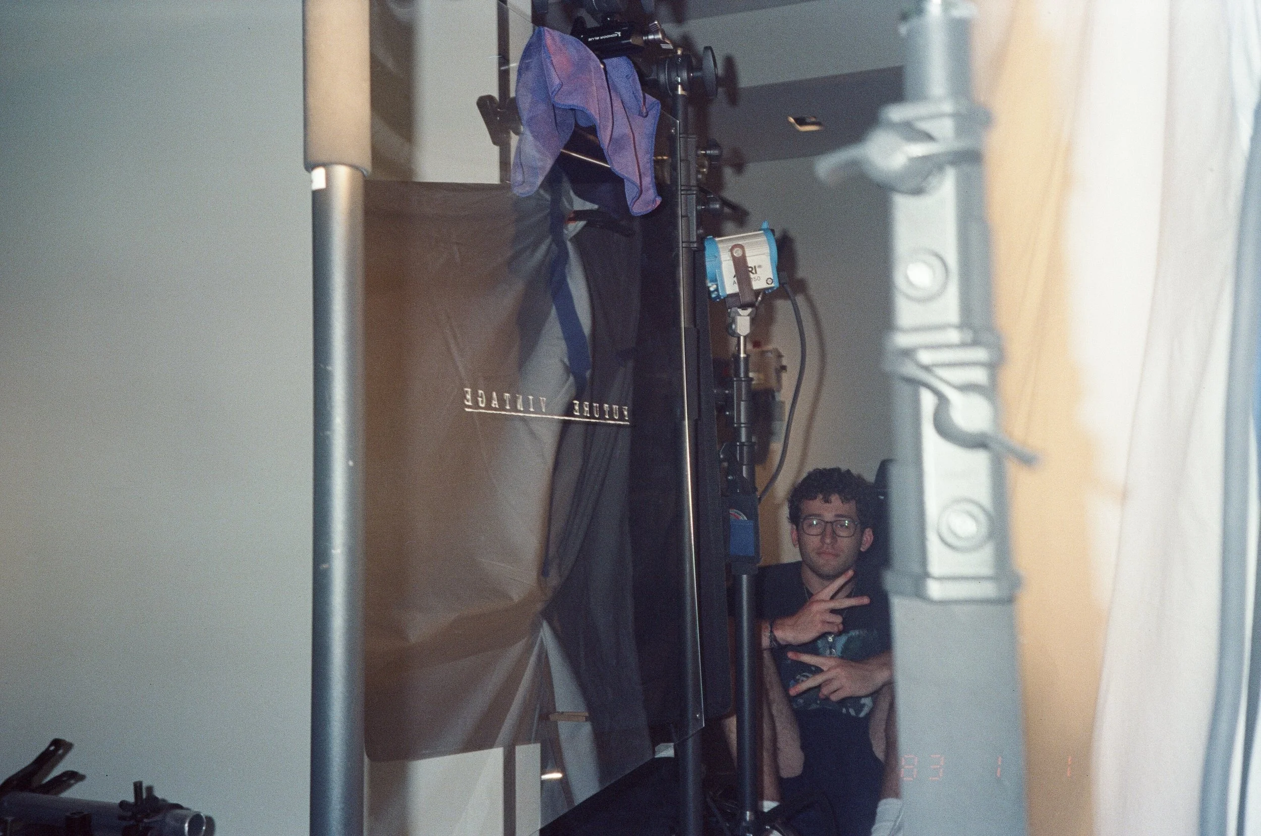 A crew member throws a peace sign, reflected with the reversed Future Vintage mark.