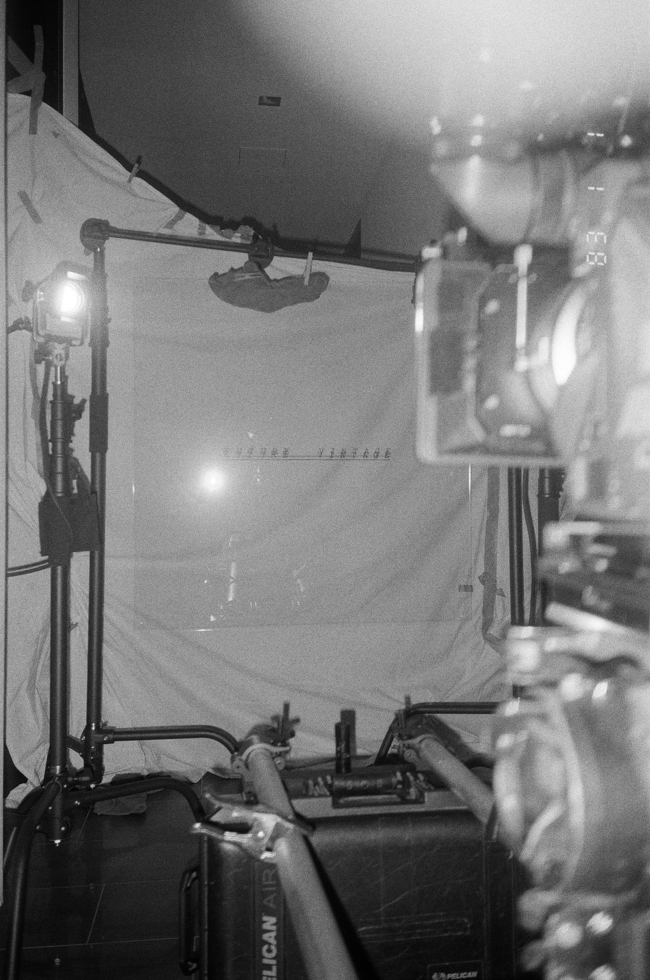 The lighting setup: stands, tungsten units and the hung Future Vintage backdrop down a corridor.