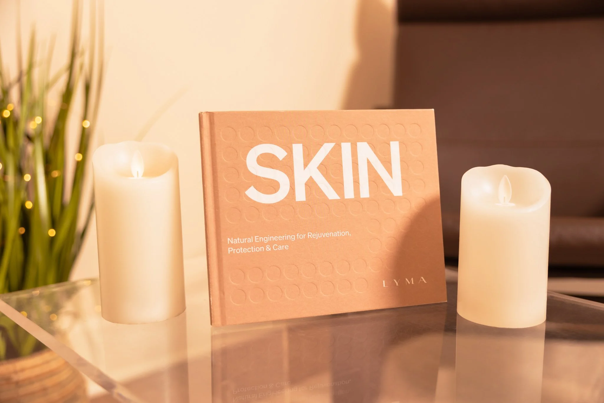 skin care book with candles and plants on a table