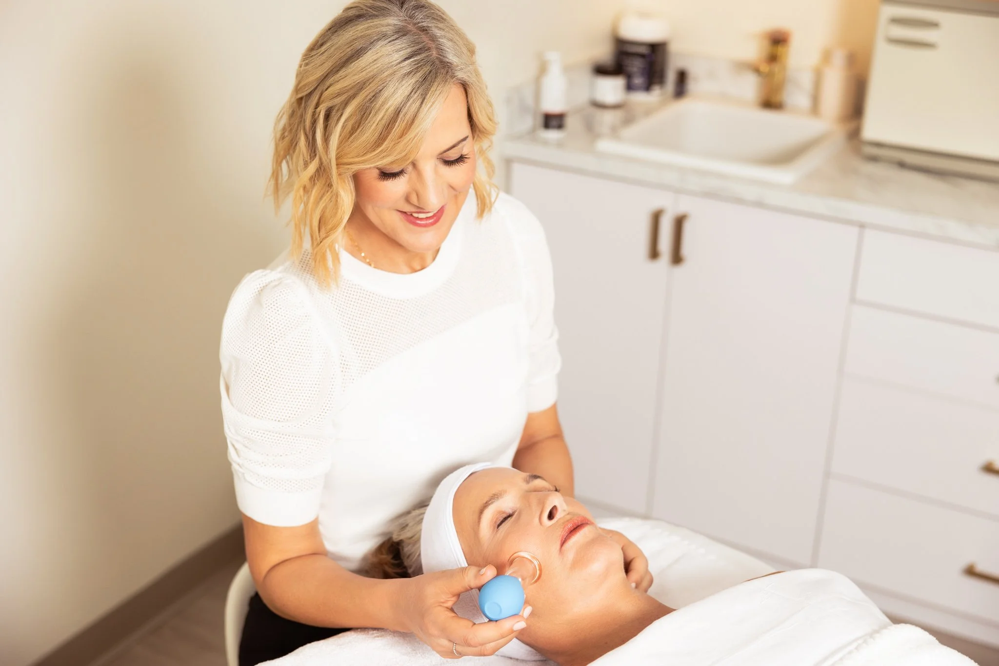 client in high end wellness spa receiving a facial cupping treatment