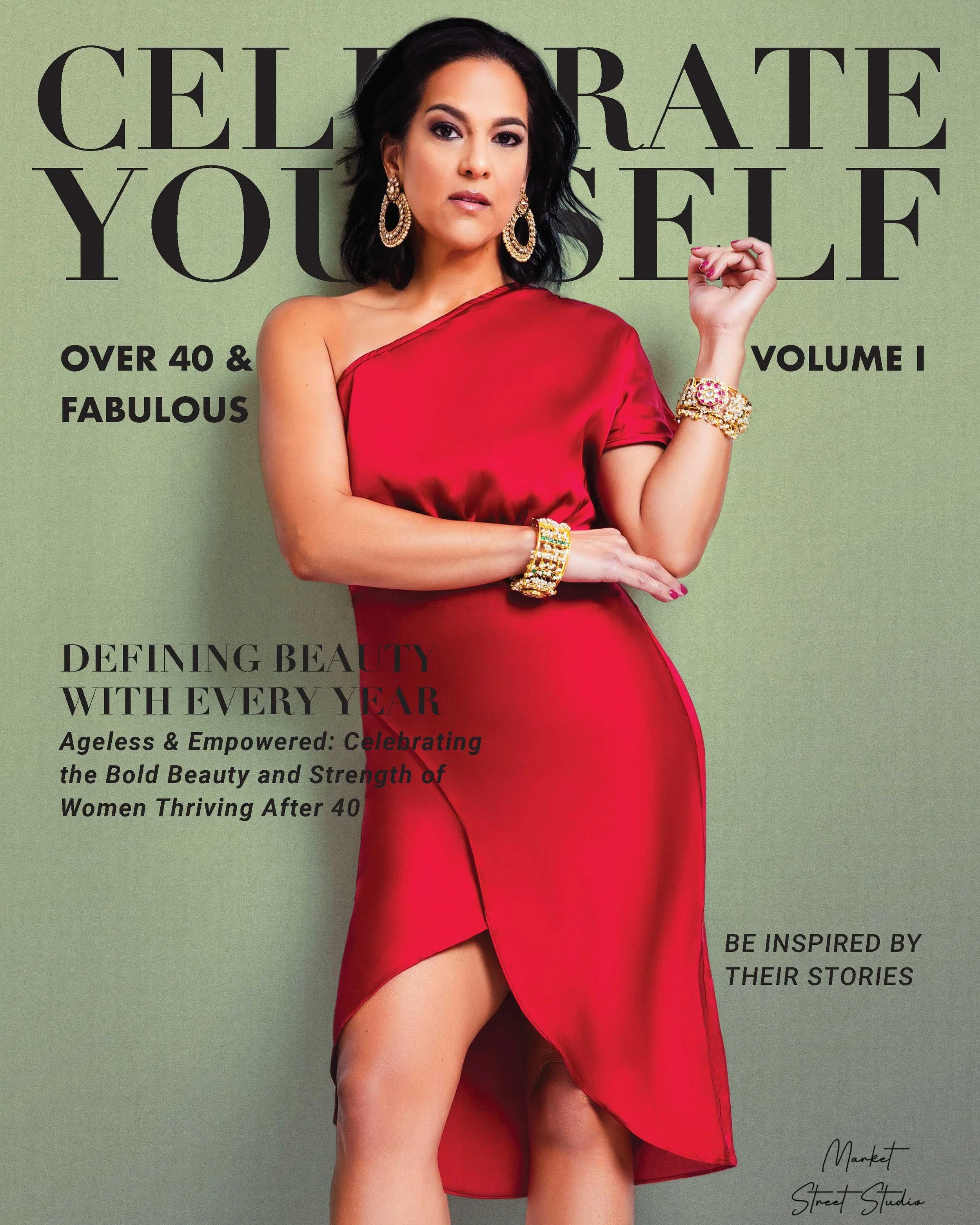 A woman in a red satin dress with jewelry, posing against a green background on the cover of a magazine.