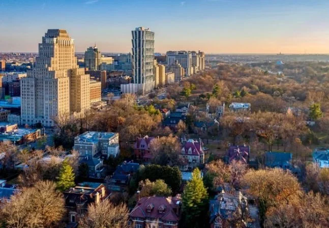 Overhead image of Forest Park, showing several tall buildings and single-family homes on tree-lined streets.