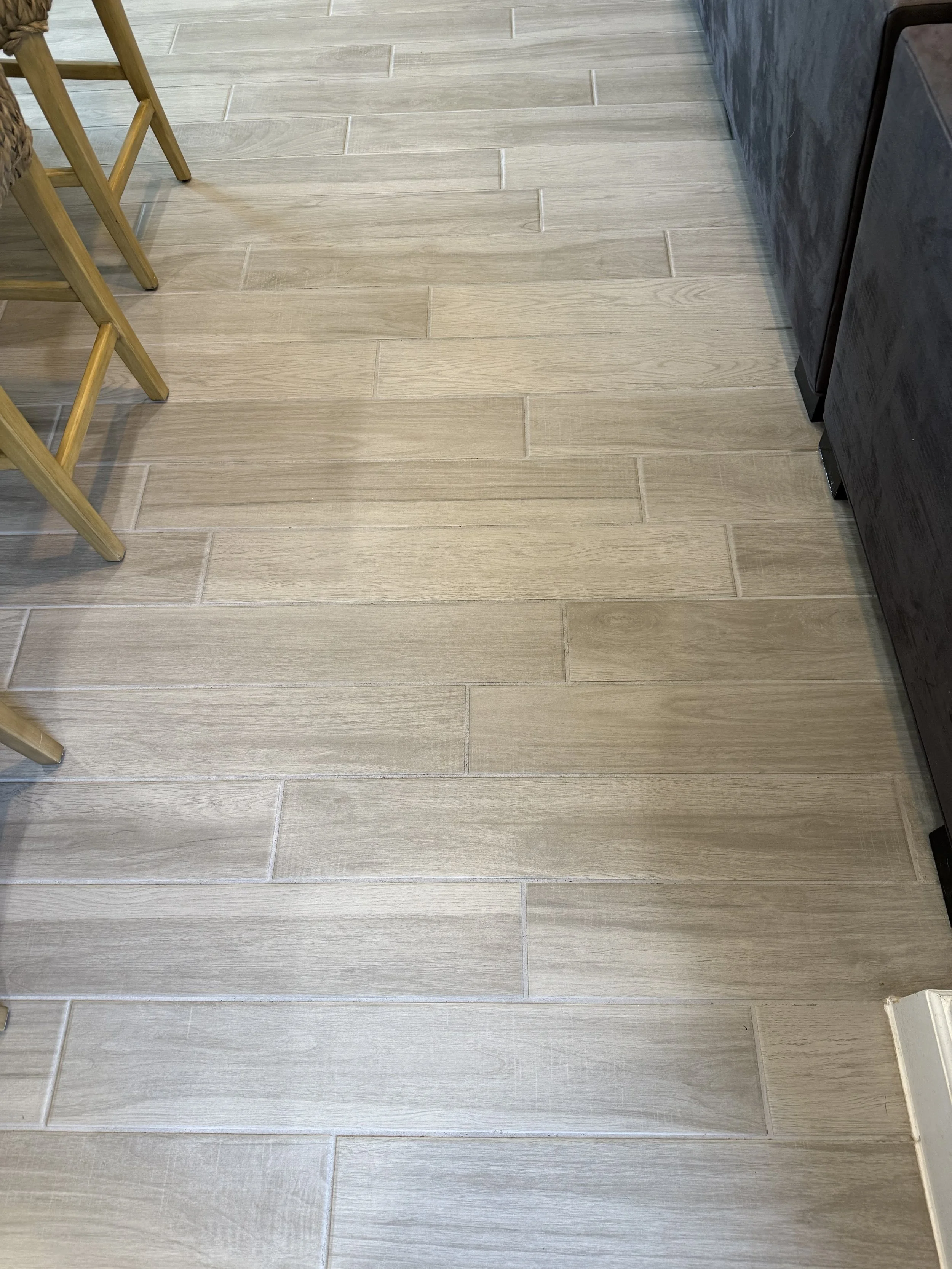 Tile and grout cleaning results for wood-look flooring in Dripping Springs, TX — restored shine and lifted soil using low-moisture cleaning.