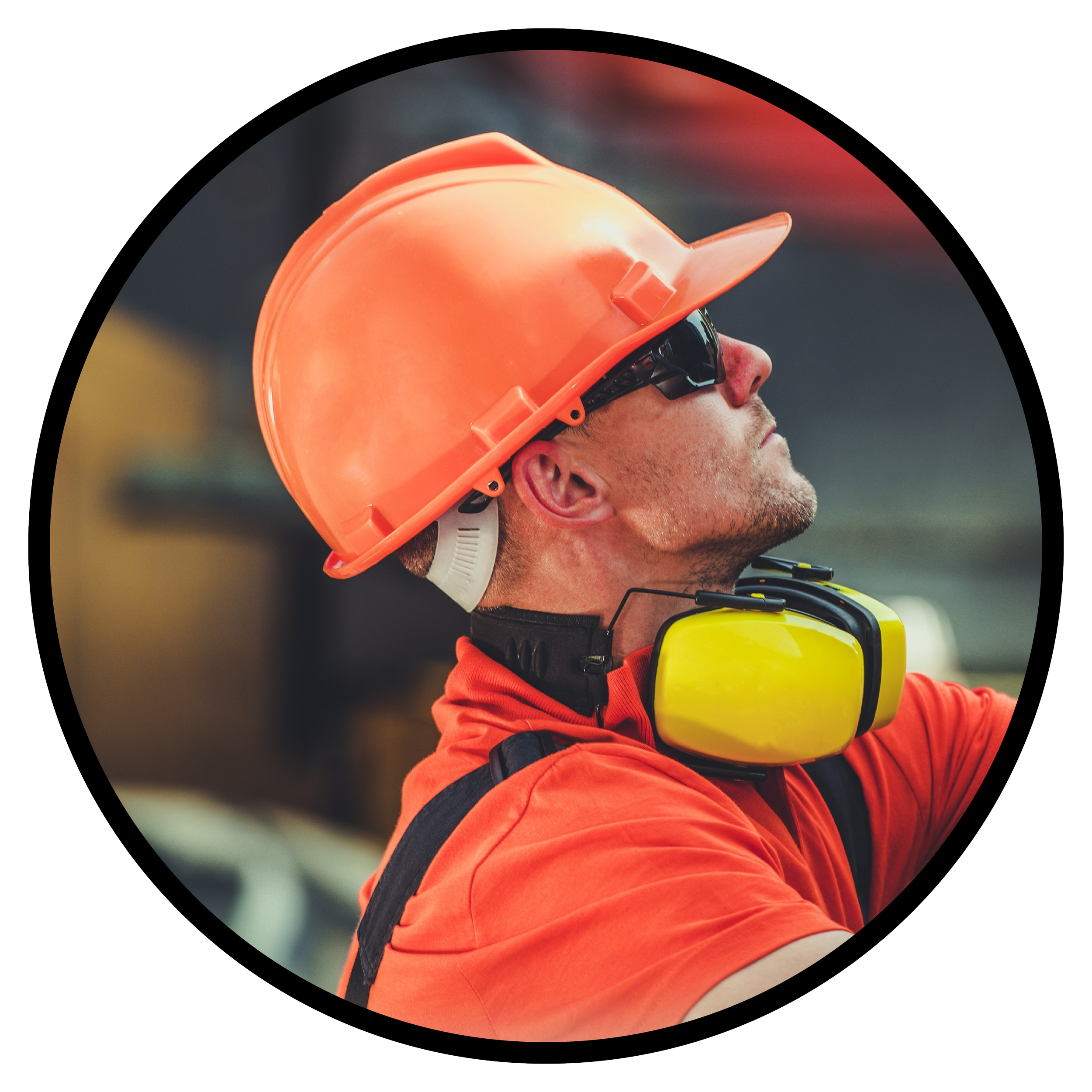 Close-up of a construction worker or rescue worker wearing an orange hard hat, safety glasses, and orange clothing, with a headset around the neck.