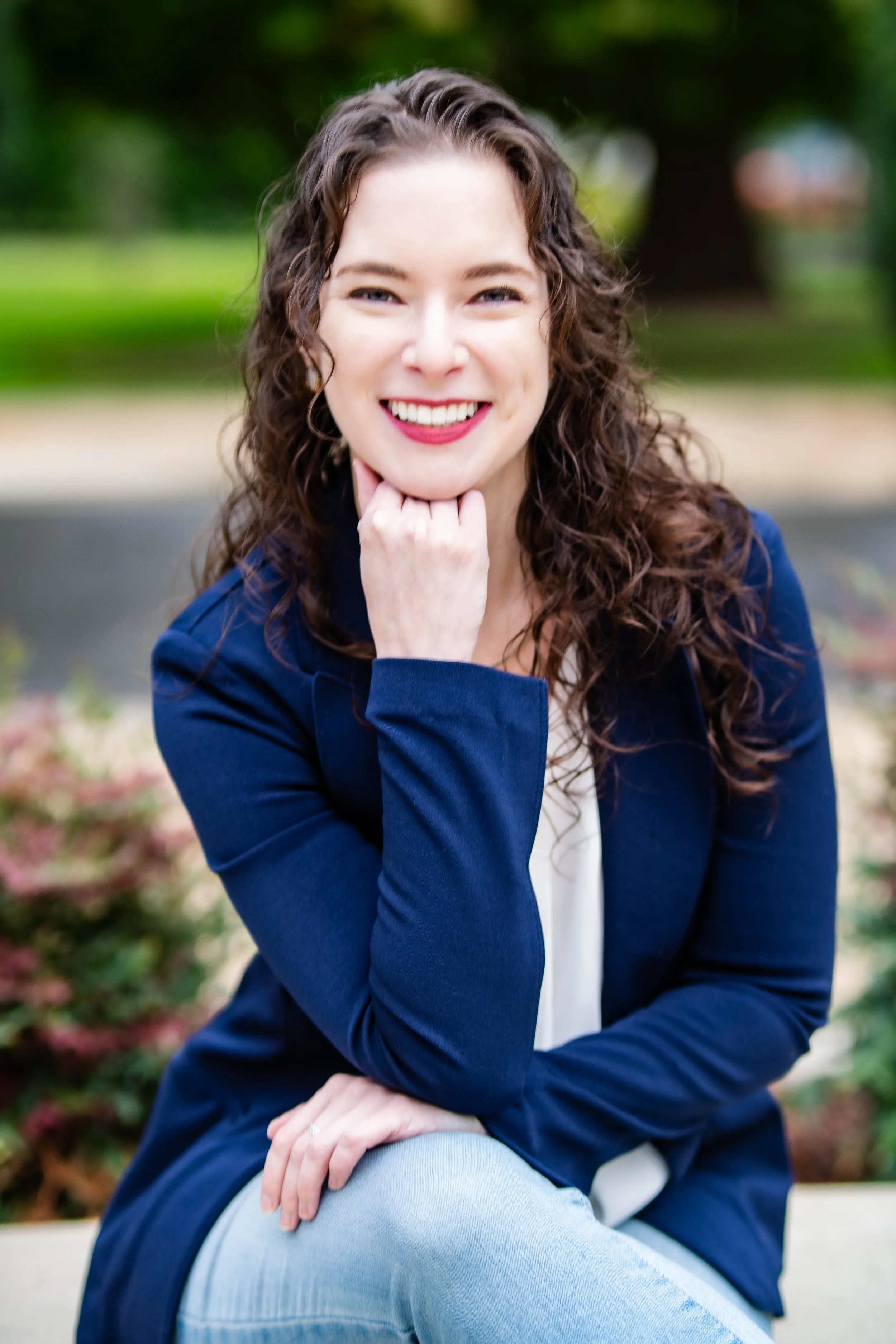 Woman sitting smiling in professional business suit