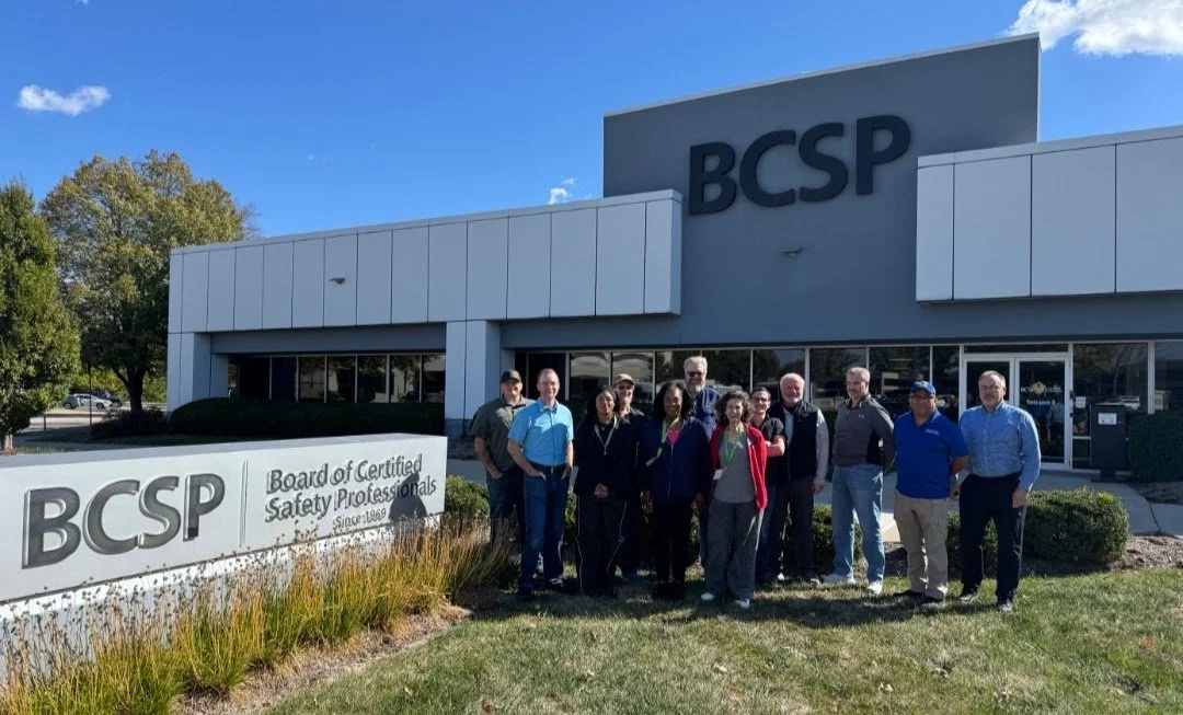 Group of people standing outside of a building with a BCSP sign and logo, which stands for Board of Certified Safety Professionals.