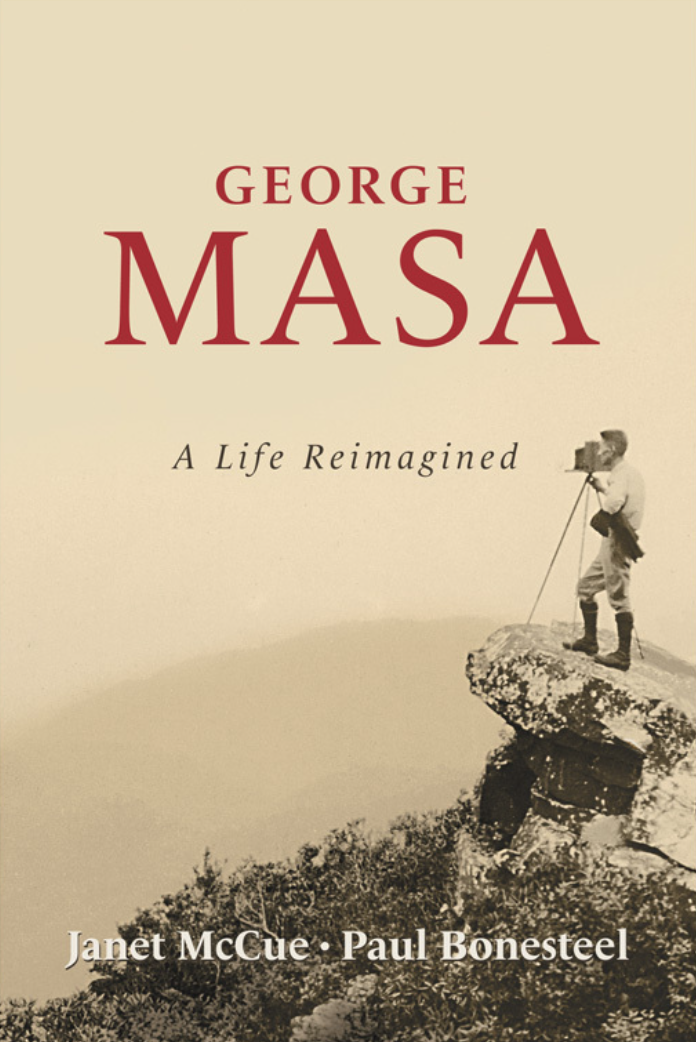 Book cover for 'George MASA: A Life Reimagined' by Janet McCue and Paul Bonesteel, featuring a black-and-white photo of a person with a camera standing on a large rock formation, looking into the distance.
