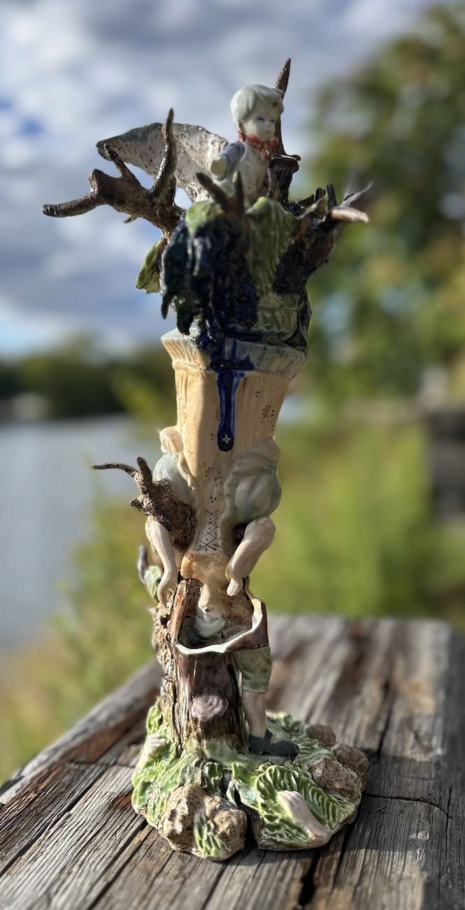 A ceramic sculpture assembled of broken figirines