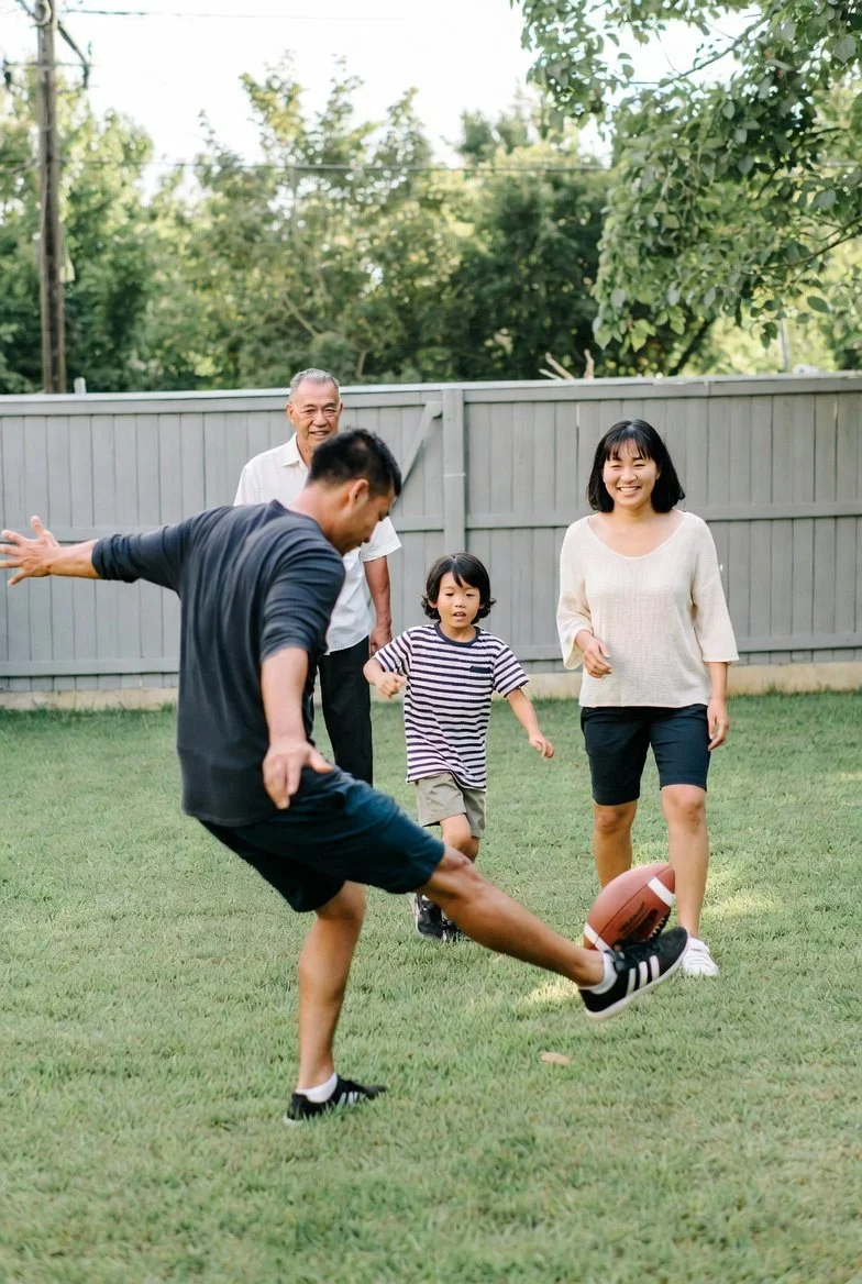 multi-generational family playing football