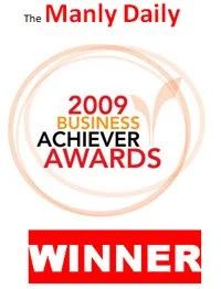 Badge or certificate from the 2009 Manly Daily Business Achiever Awards, indicating the recipient is a winner.