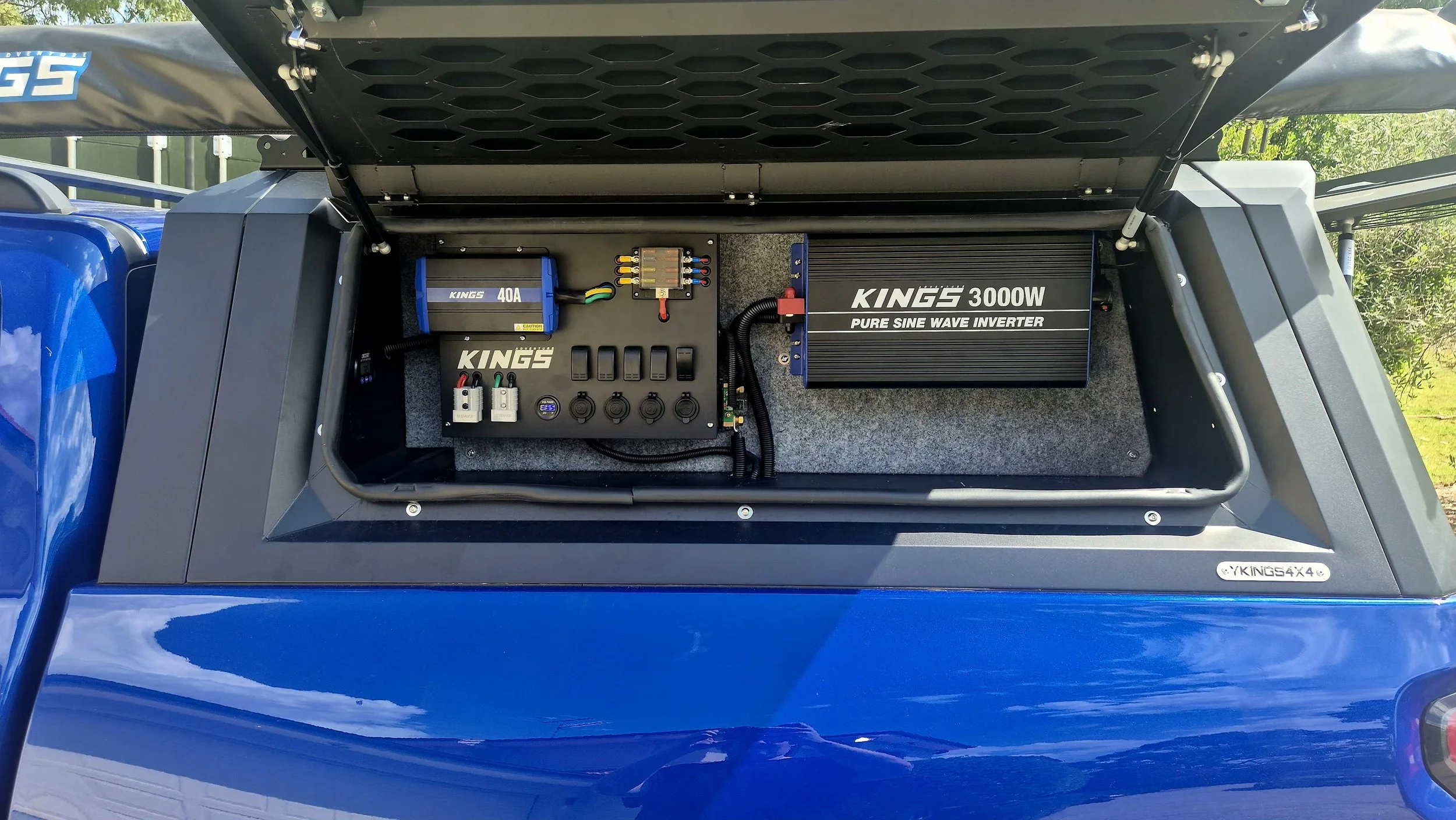 The image shows a vehicle's open compartment with electronic equipment, including a Kings 3000W pure sine wave inverter, a Kings 40A fuse box, wiring, and switches, installed on a soundproofed surface.
