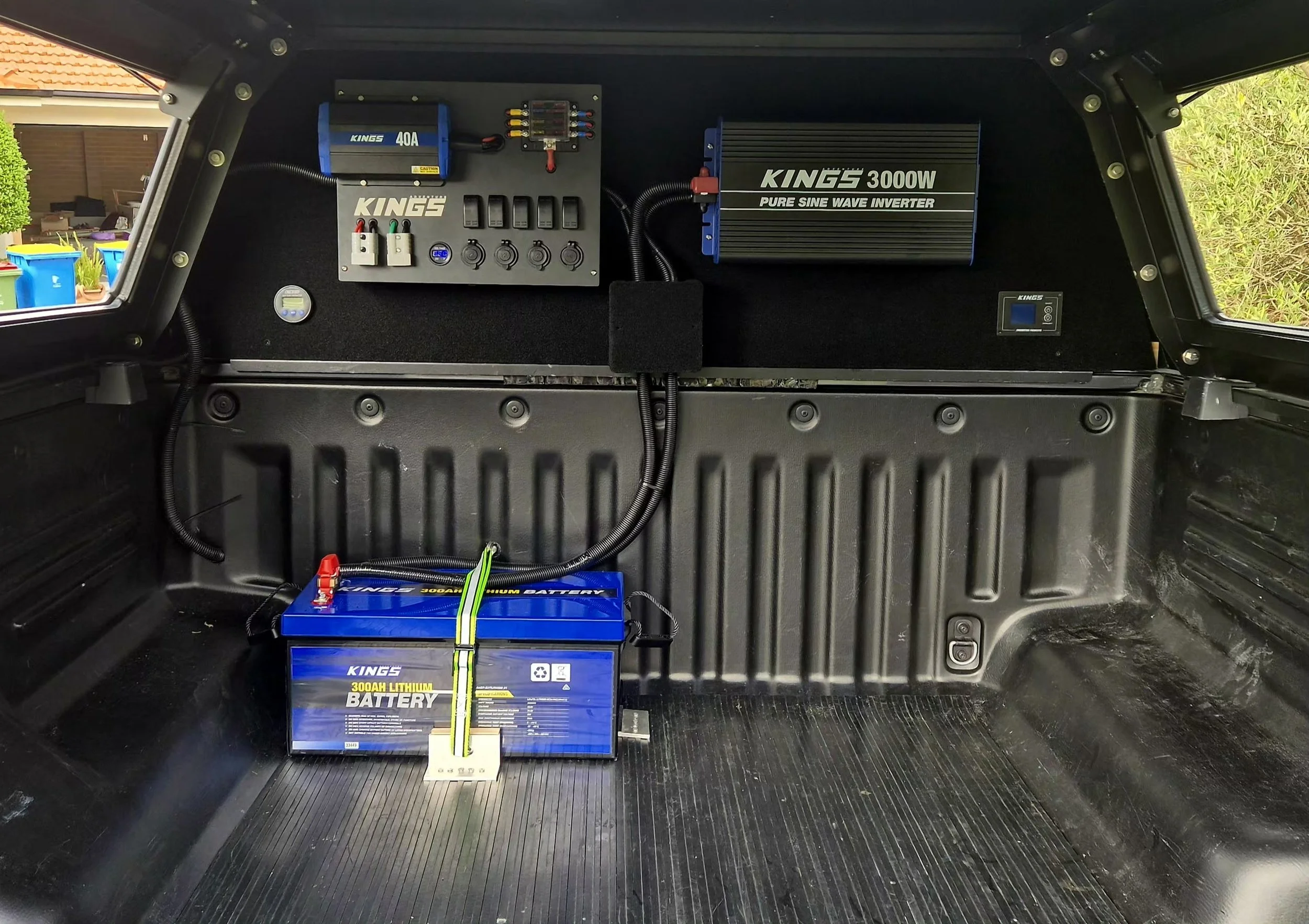 Battery system with lithium battery, inverter, and wiring installed inside a vehicle's cargo area.