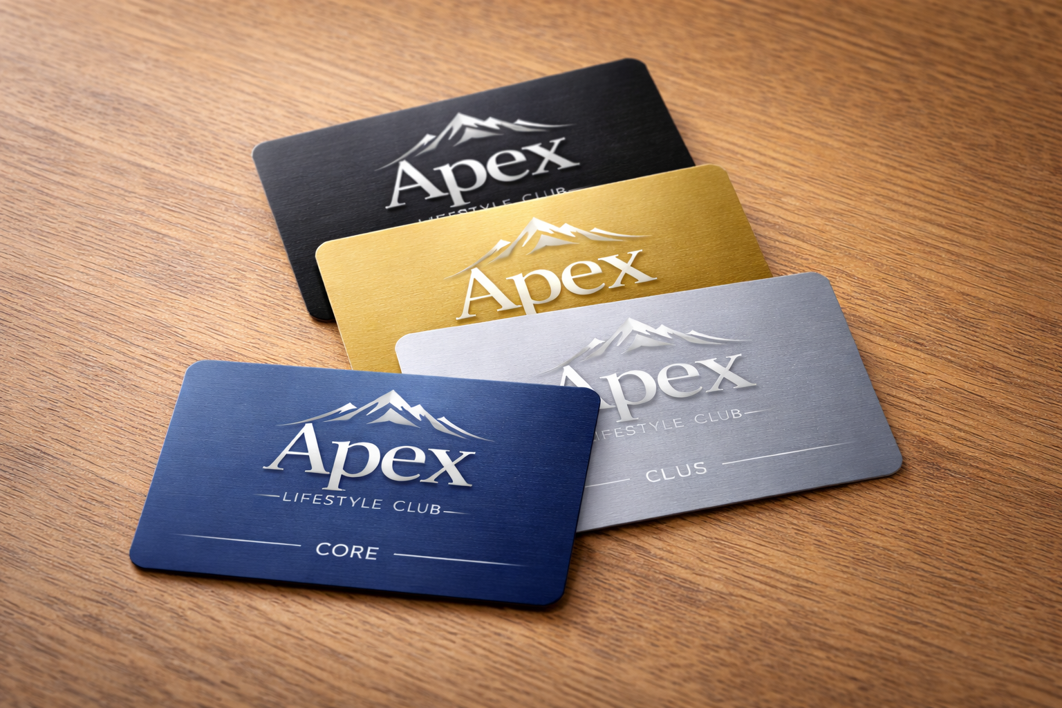 Four colored membership cards for Apex Lifestyle Club in black, gold, silver, and blue are stacked on a wooden surface.