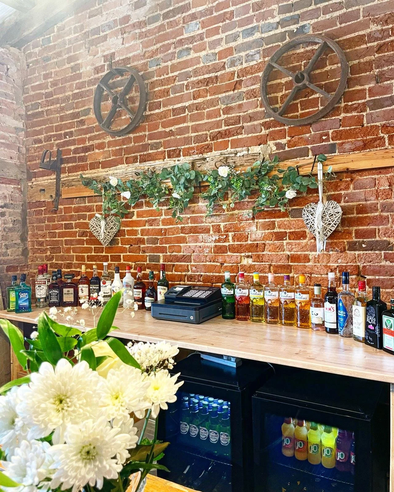 wedding bar hire at Glebe Farm Barn Norfolk. Back bar showing a range of drinks