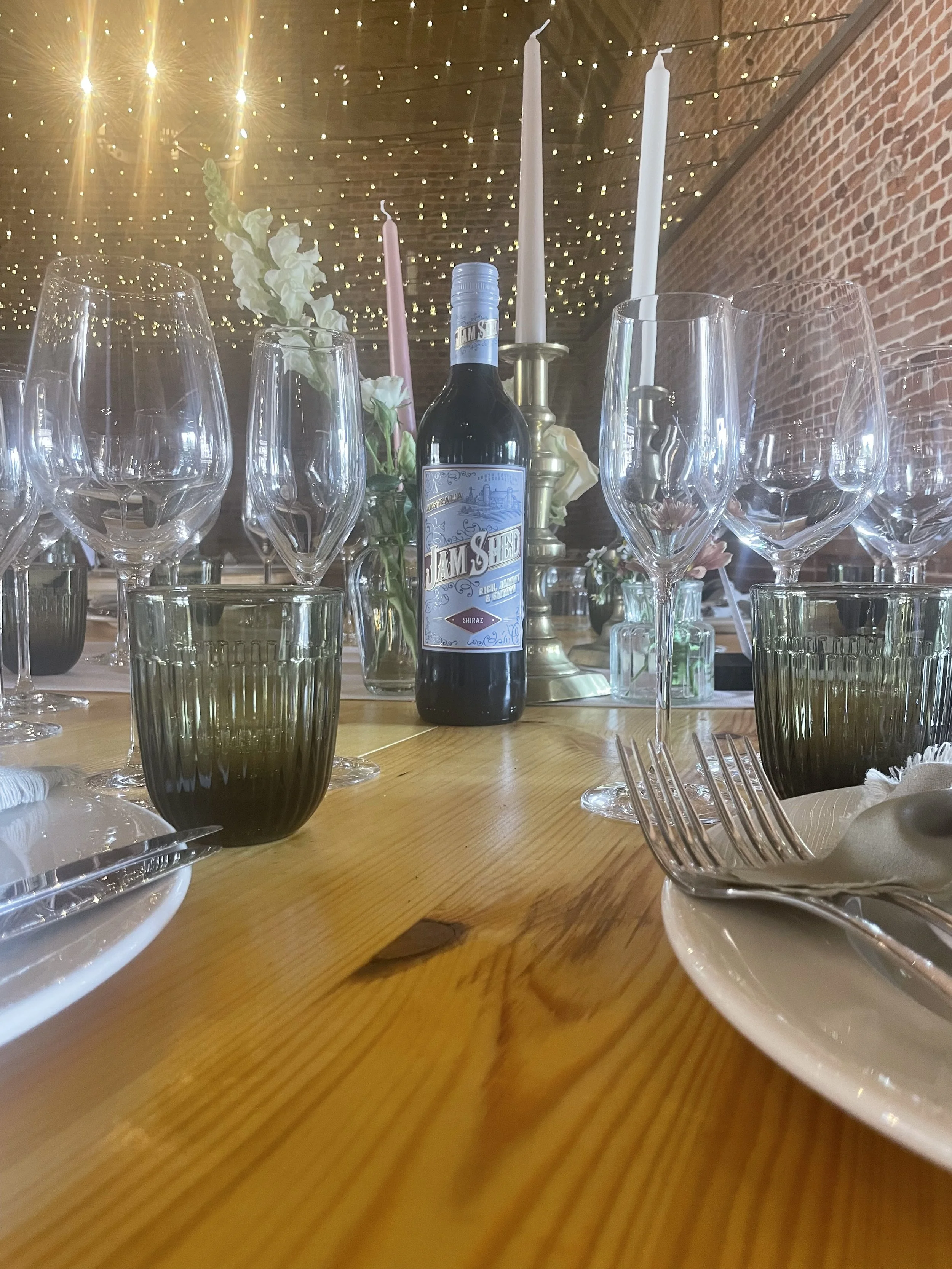 champagne flutes, wine glaases and water tumblers set ready for wedding breakfast