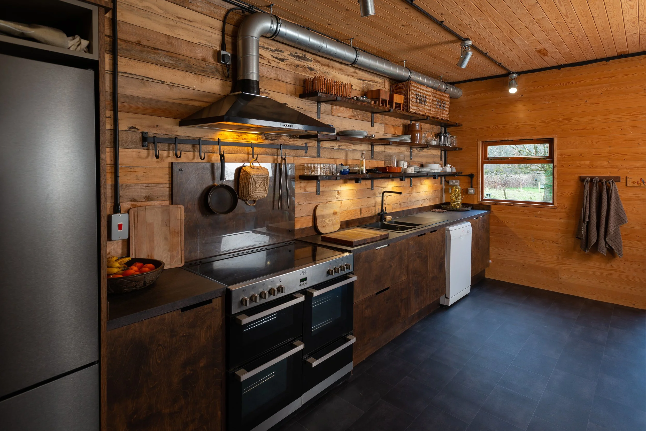 Close by, this hiker's barn has a hardworking kitchen in a similar style.