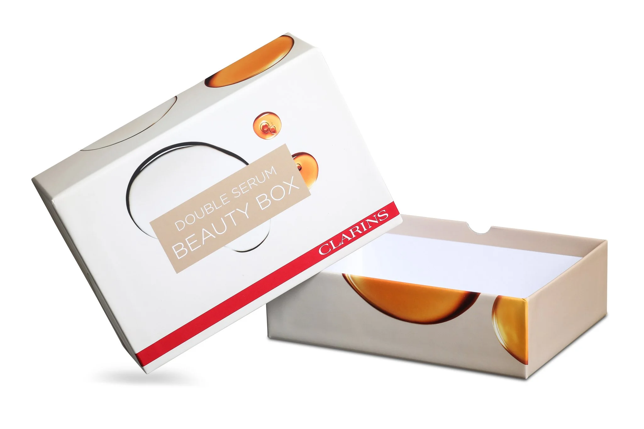 Open Clarins double serum beauty box with inner tray removed, white box with orange and beige accents, and Clarins logo in red at the bottom.