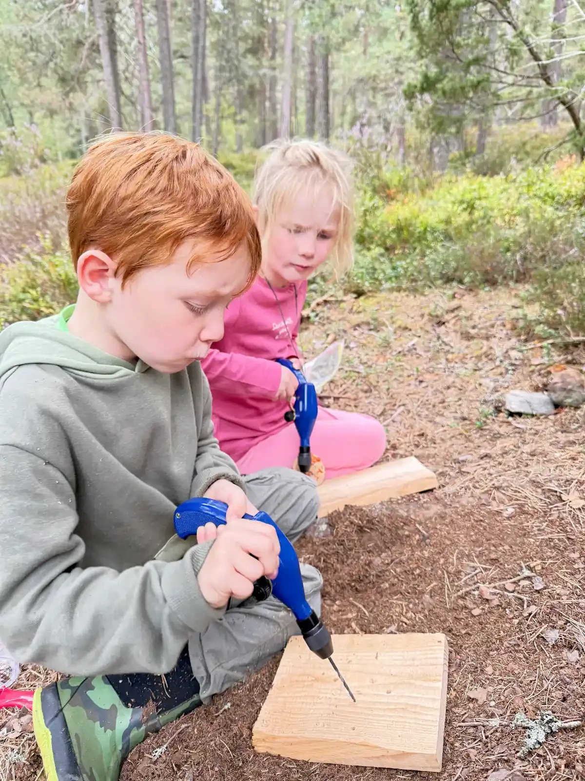 kids learning to use drill while crafting