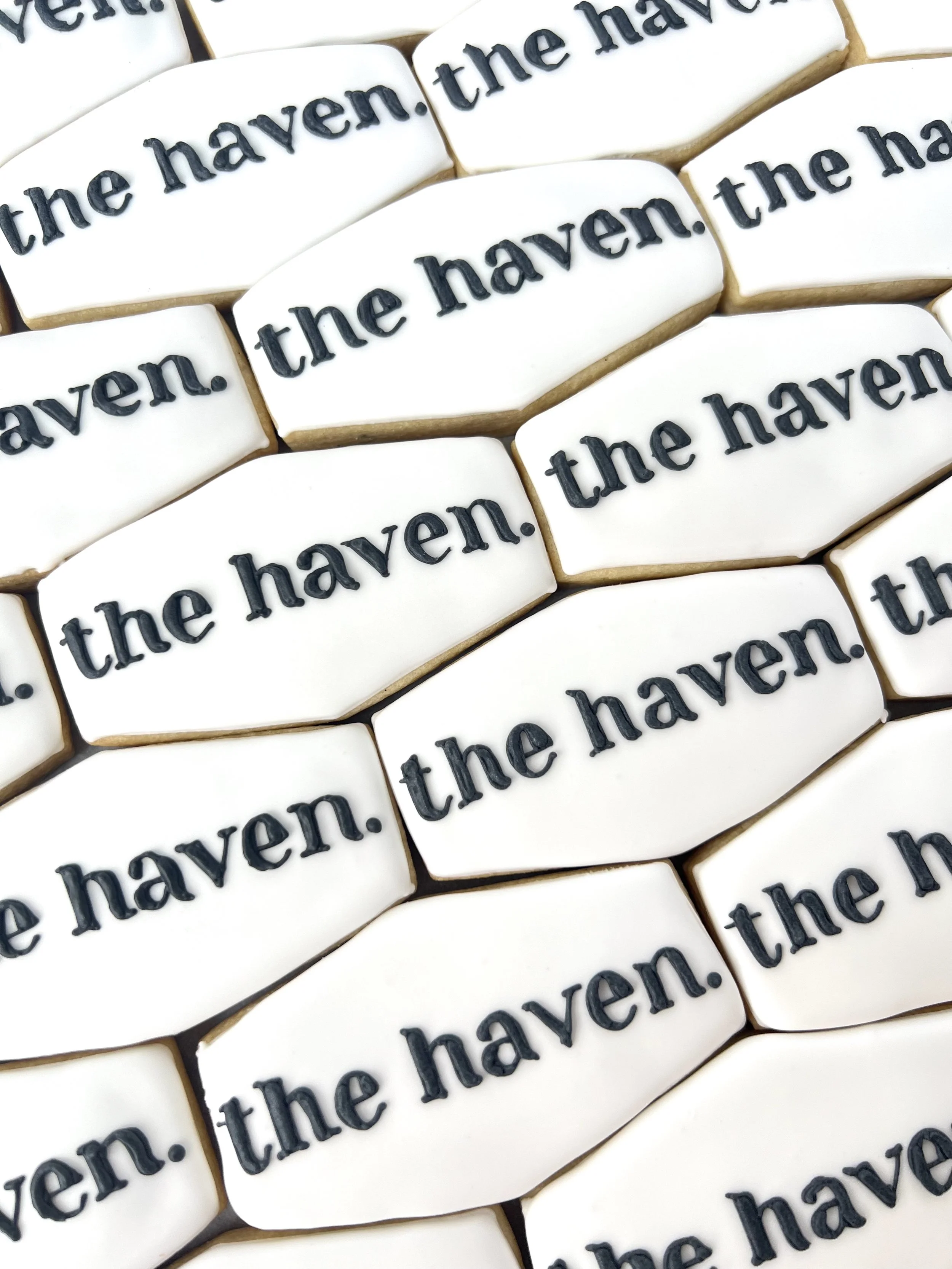 White hexagon cookies with "the haven" in black on each cookie.