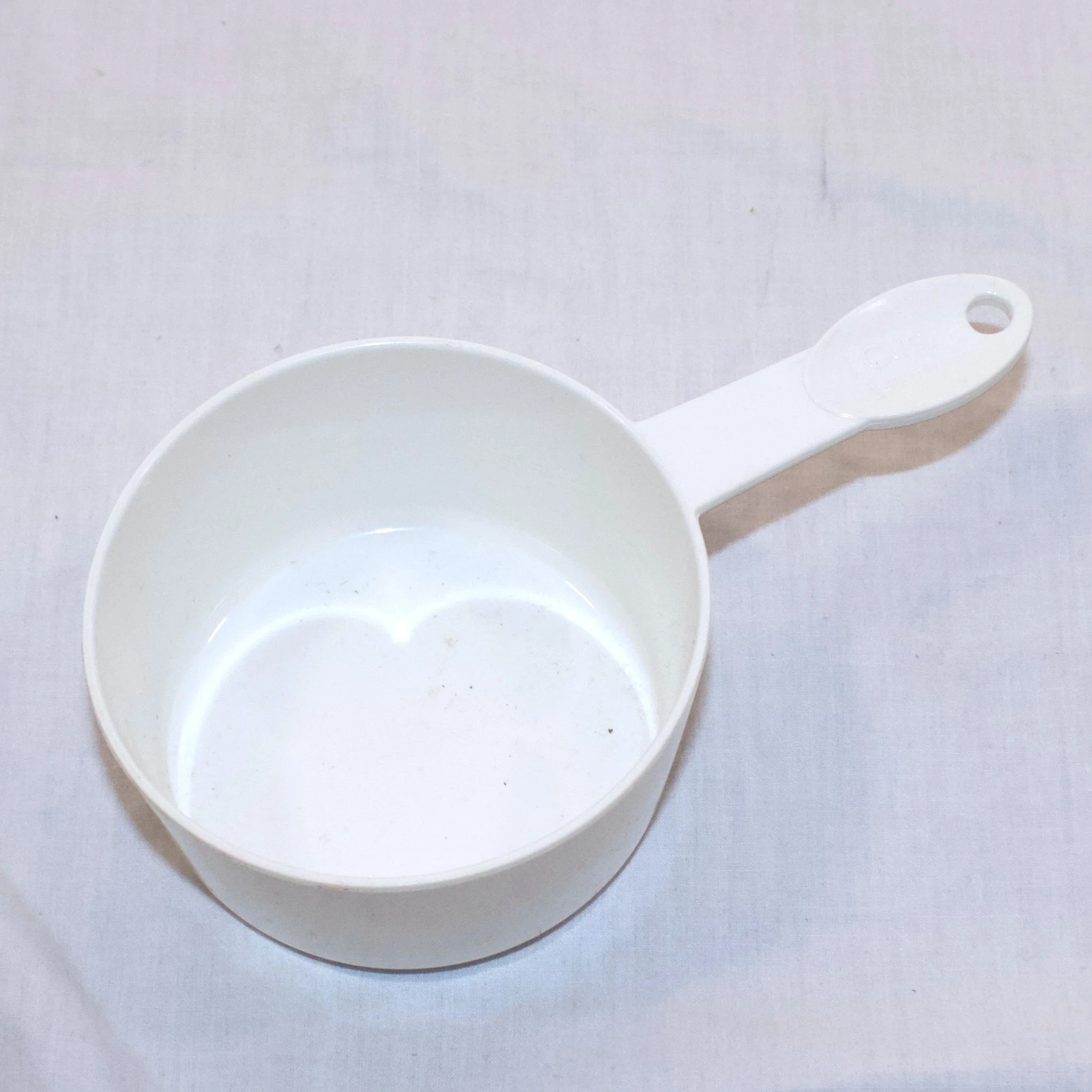 white measuring cup turned.jpeg