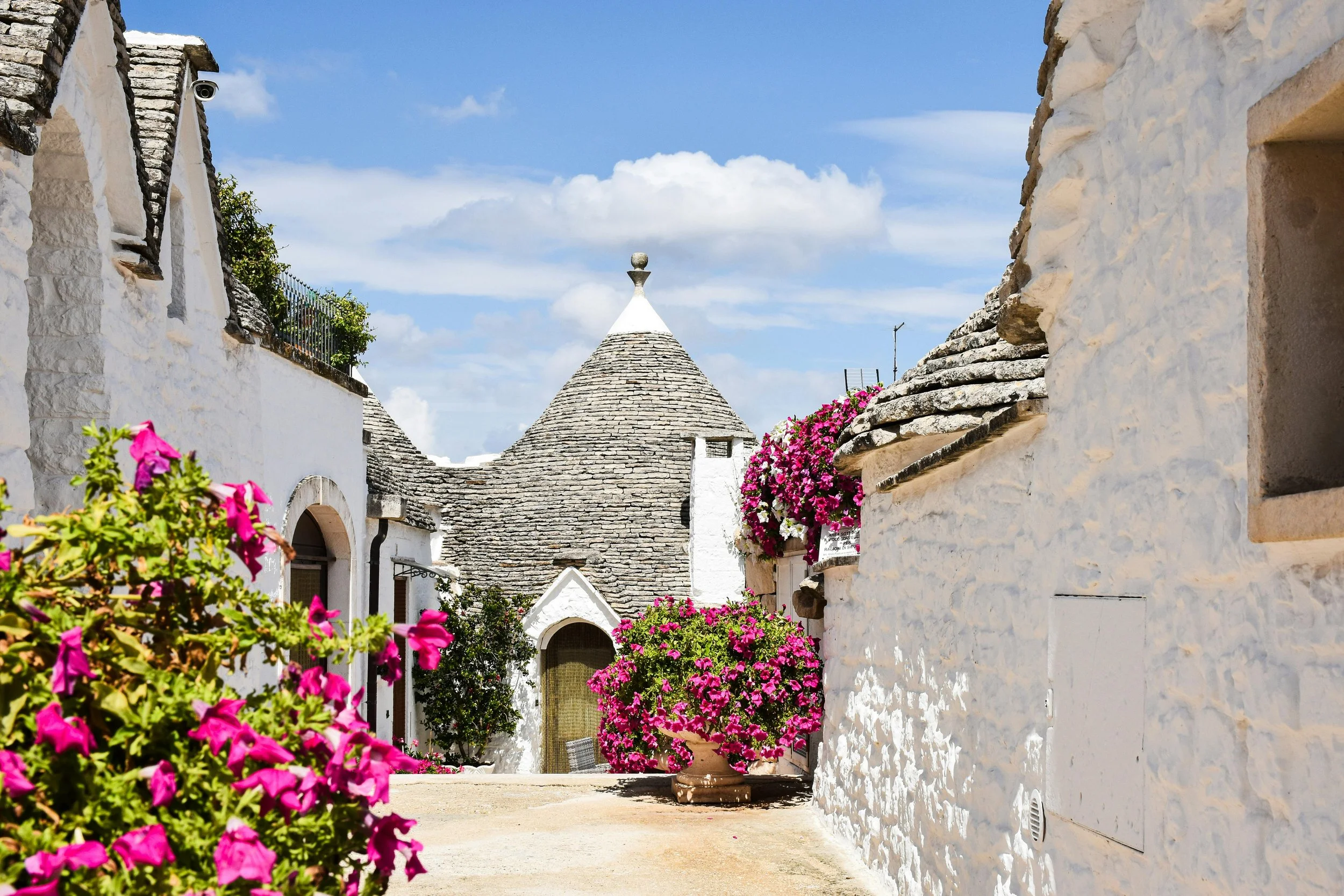 Premium Italy travel consultation 15 day custom itinerary authentic traditional architecture experiences Traditional trulli houses with conical stone roofs in Alberobello, Italy
