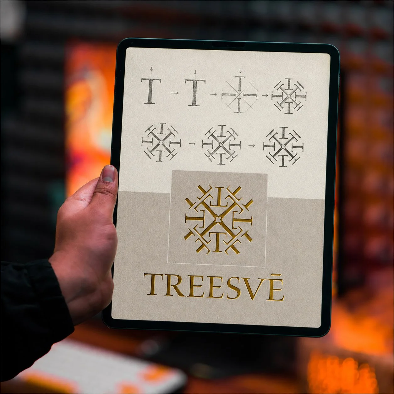 Man holding an iPad with creative work produced by Trilambs