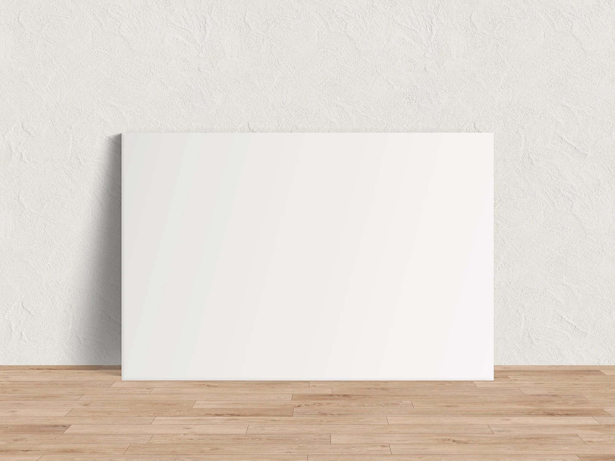 Horizontal canvas wrap mockup leaning against a textured plaster wall on a light hardwood floor
