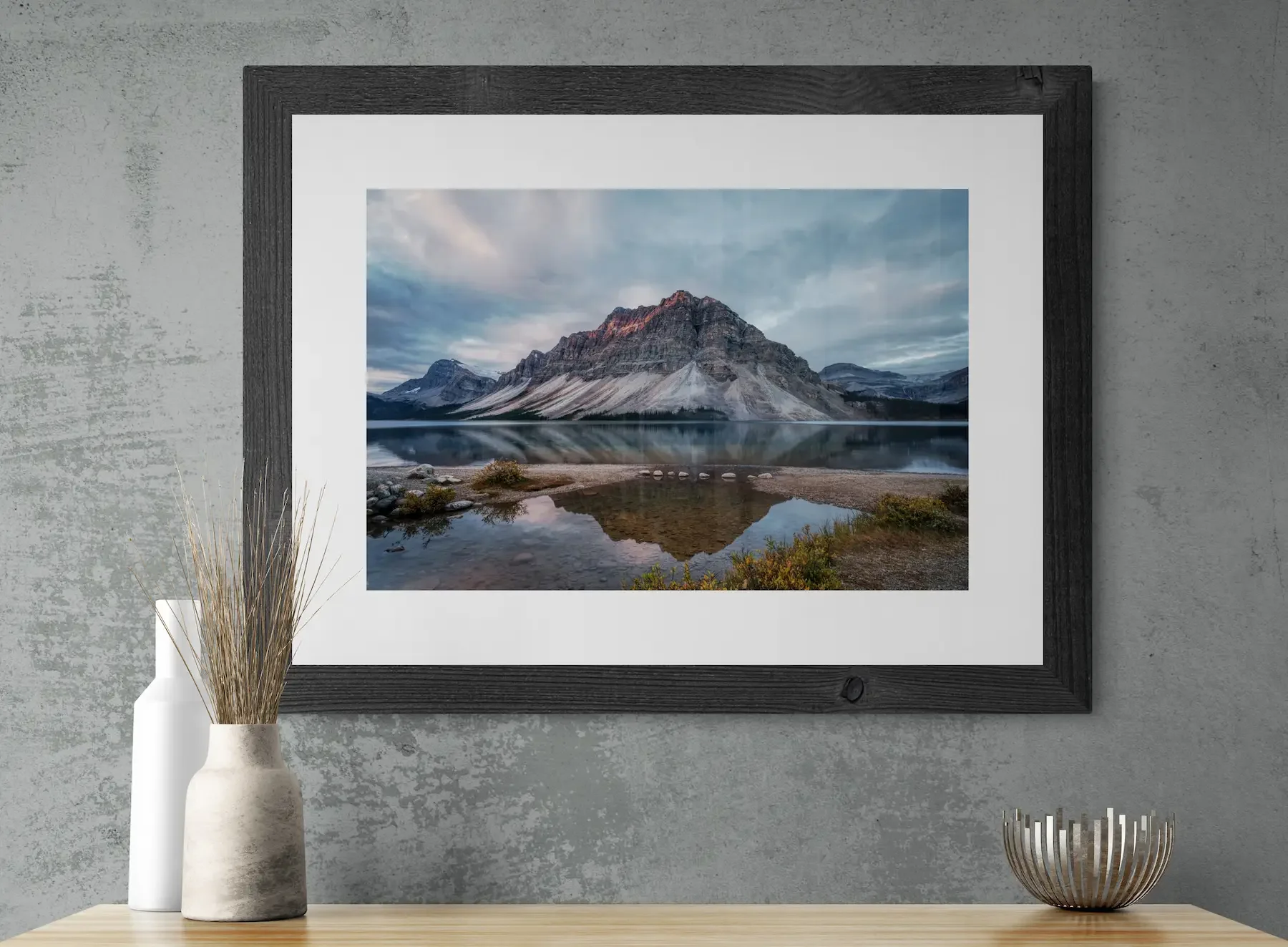 Bow Lake print with mat framed above counter with vases