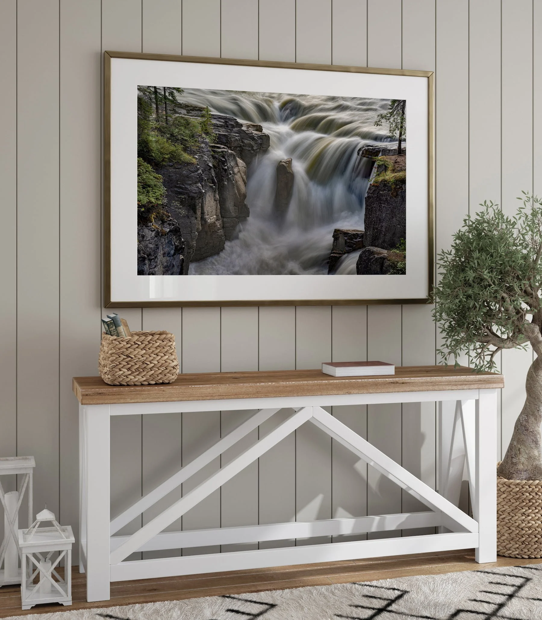 Sunwapta Falls landscape print in a gold metal frame with white mat, hung above a rustic farmhouse console table.