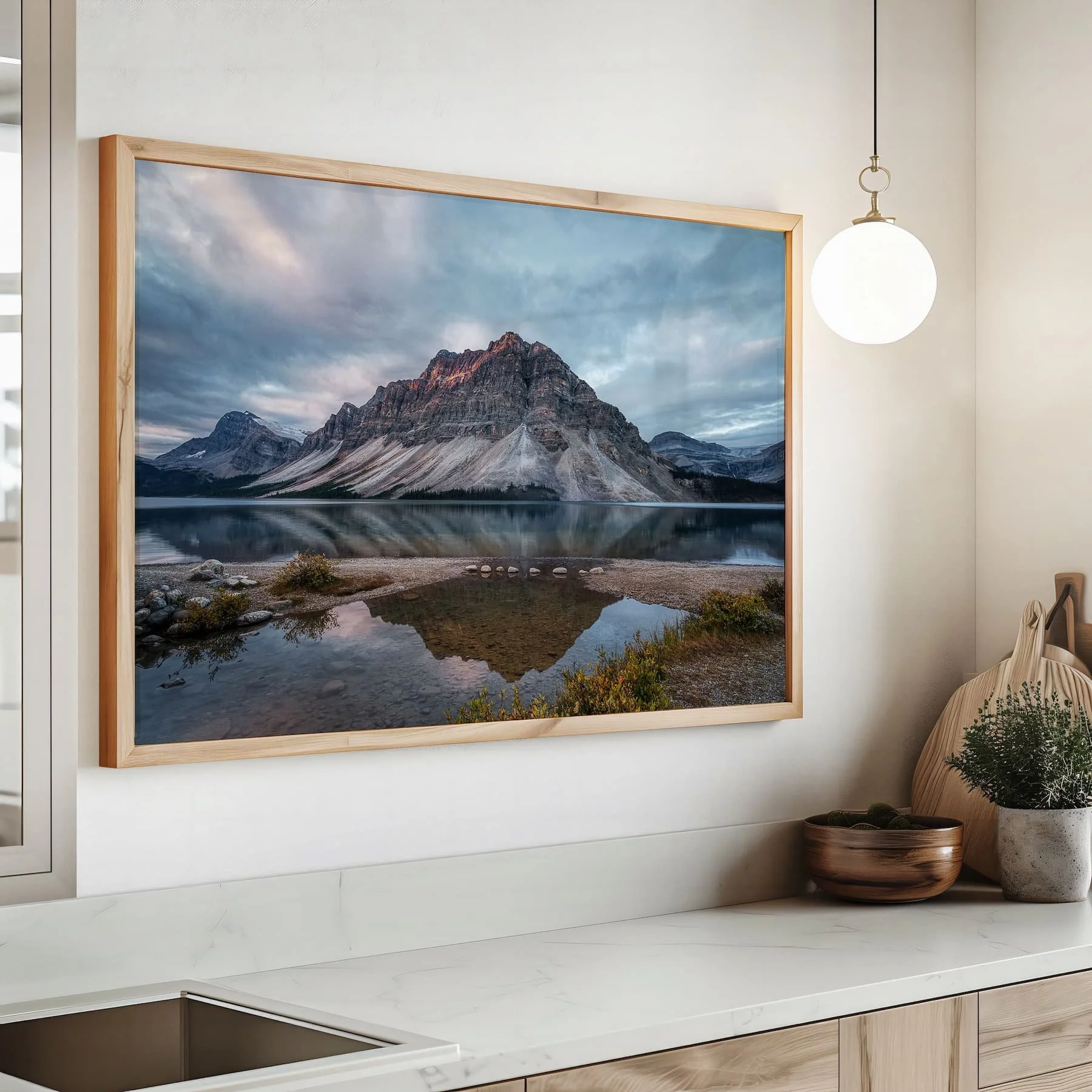 Bow Lake Reflections fine art print framed on the wall above the counter.