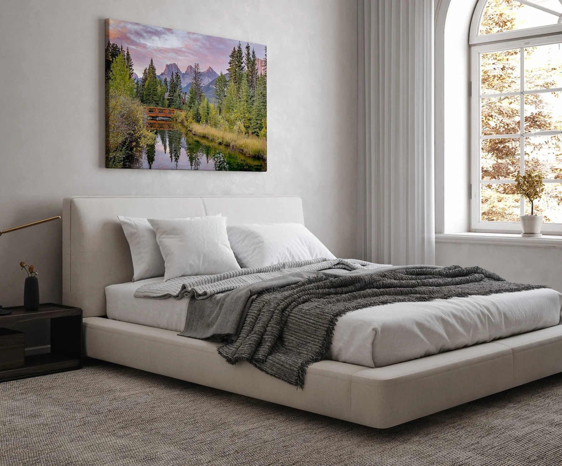 Three Sisters Sunrise large canvas print in a bedroom hanging over the headboard.