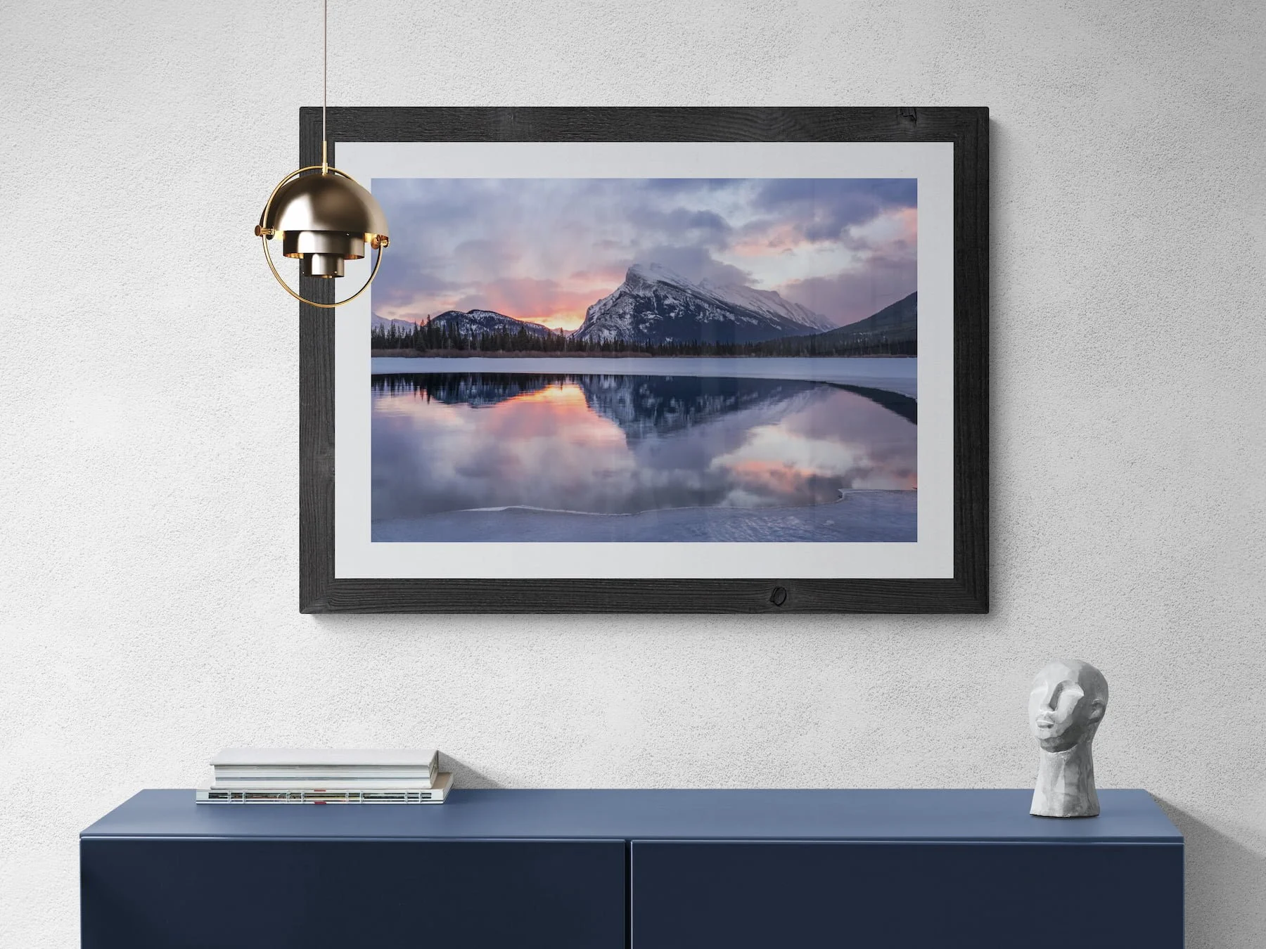 Mount Rundle Reflections fine art print with walnut frame and mat minimal room with modern cabinet.