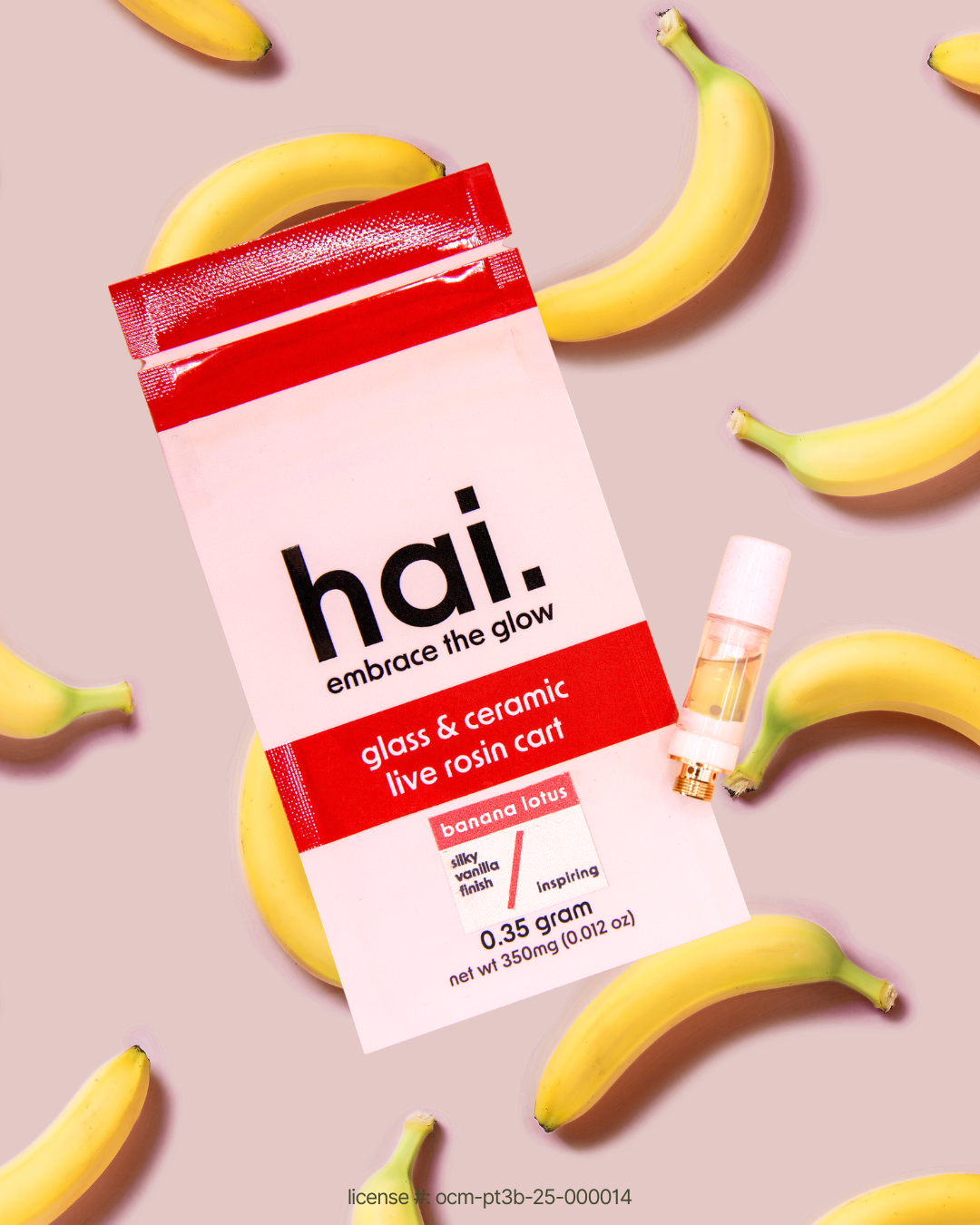 hai. banana lotus 0.35g live rosin 510 cartridge package photographed with fresh bananas on a pink background, featuring glass and ceramic hardware.