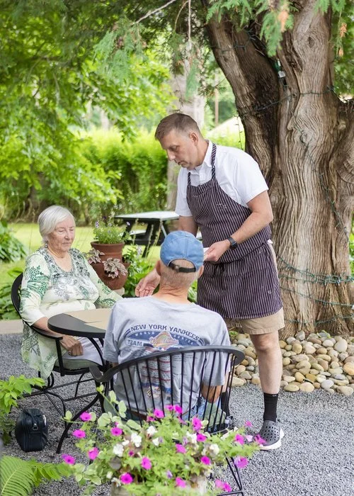 Business owner serving customers at his cafe in a small town in upstate New York