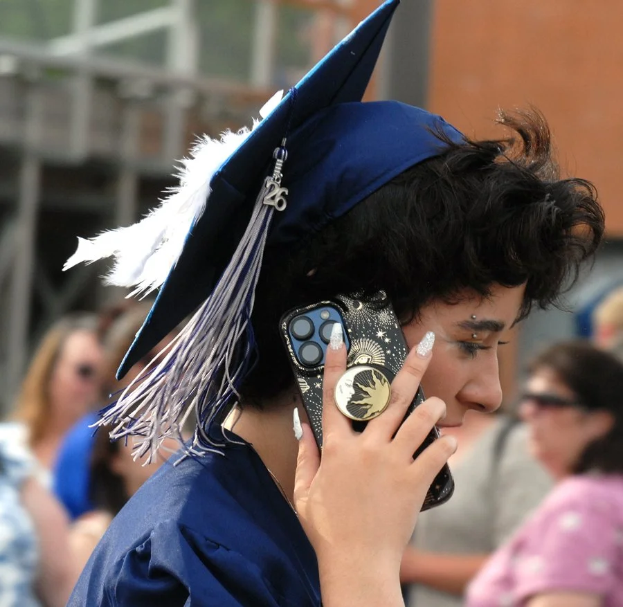 CR grad. Evan on phone.jpg