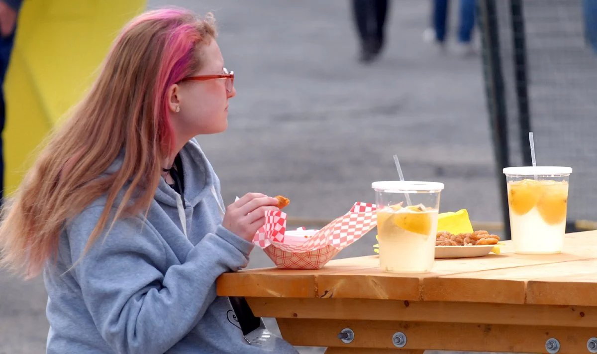 Girl drinks lemonade at Maple Festival