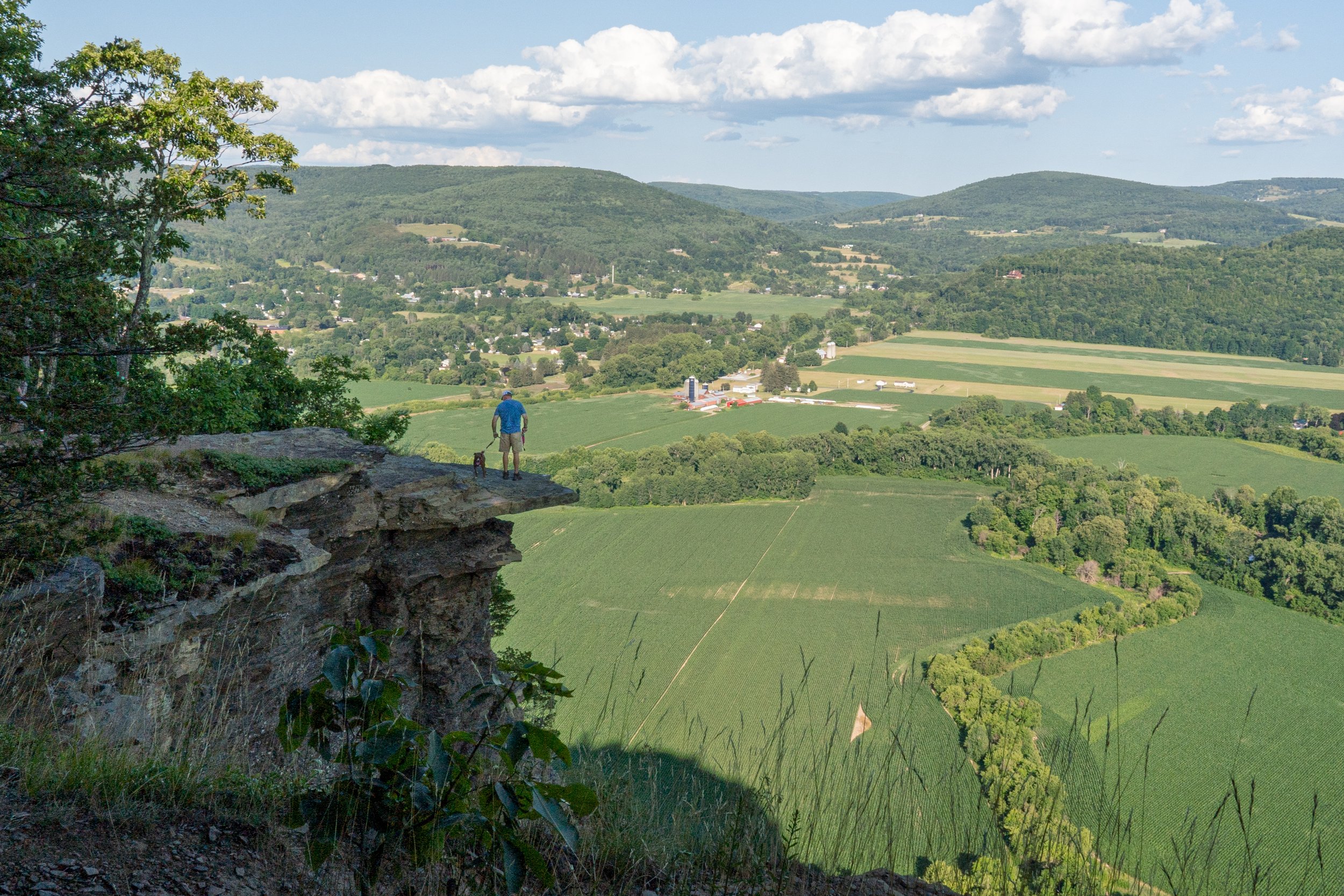 A man and a dog at Vrooman's Nose overlooking the Schoharie valley in upstate New York