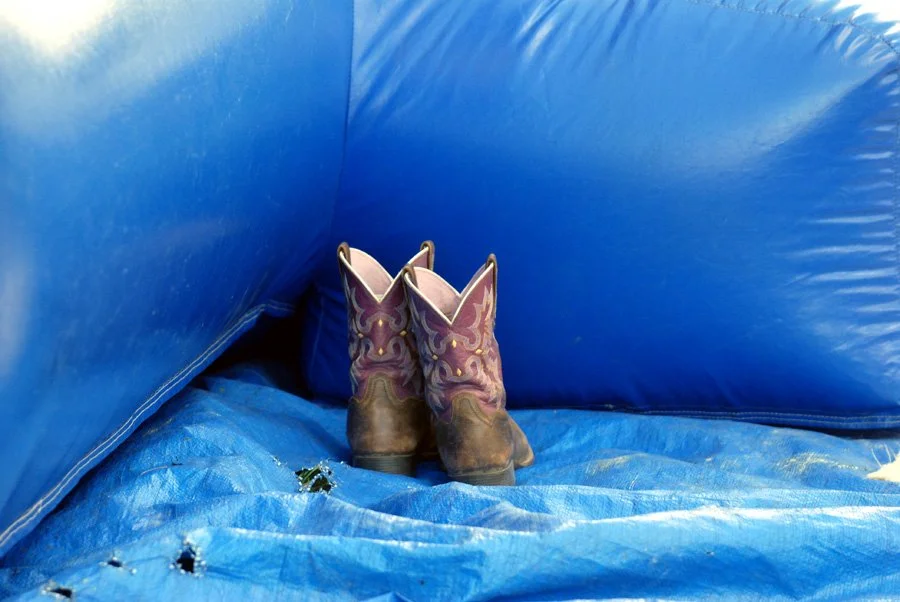 Cowboy boots outside the bounce house.