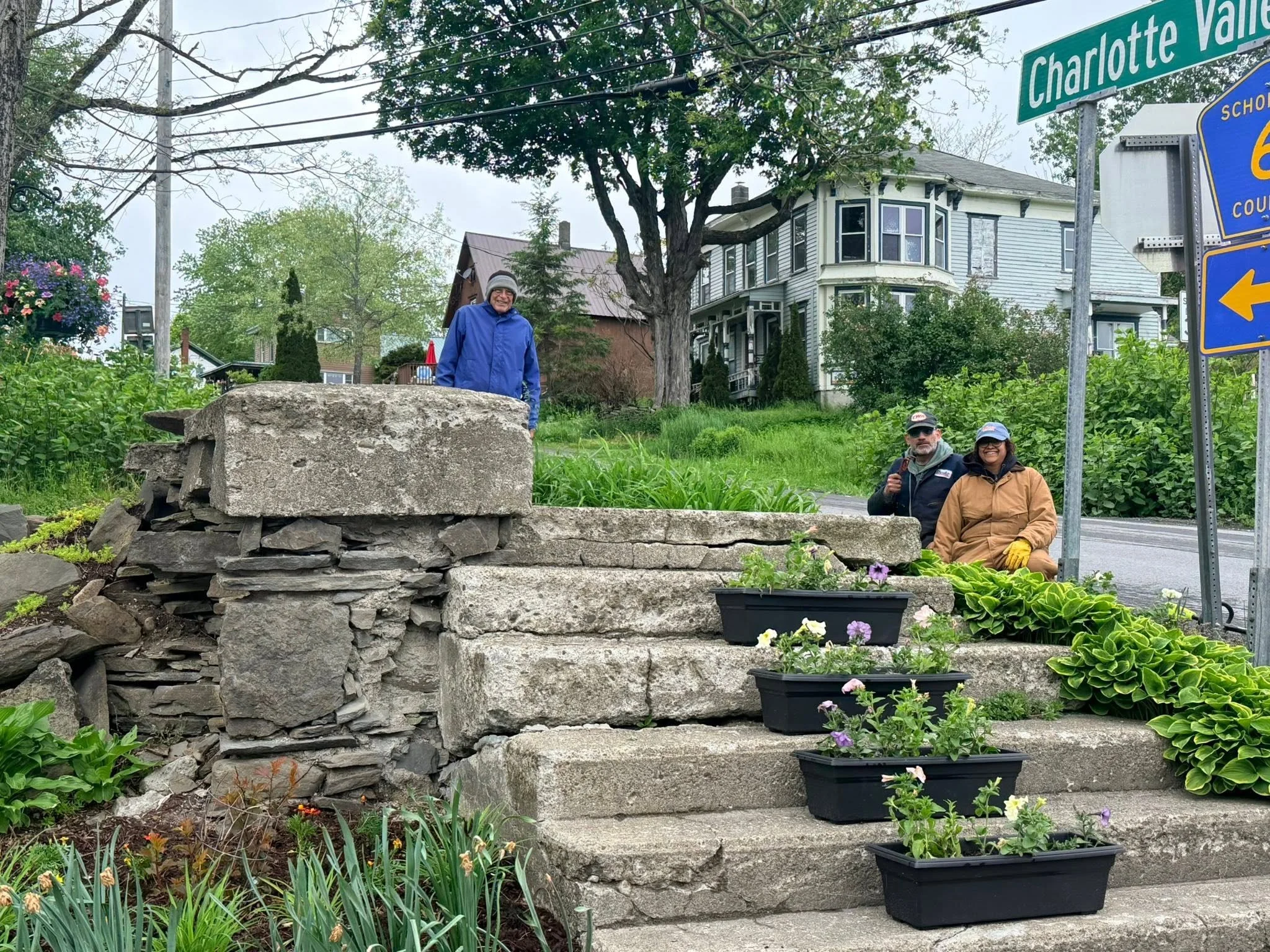 Some of the Summit Neighbors pause in their planting at the Steps Garden.
