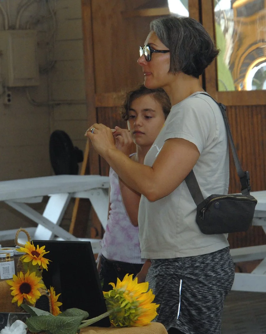 Jackie Hadam of Schoharie sample sunflower butter from Redhook Dreams at the Schoharie County Farmers Market.s sunflower butter from  Redhook