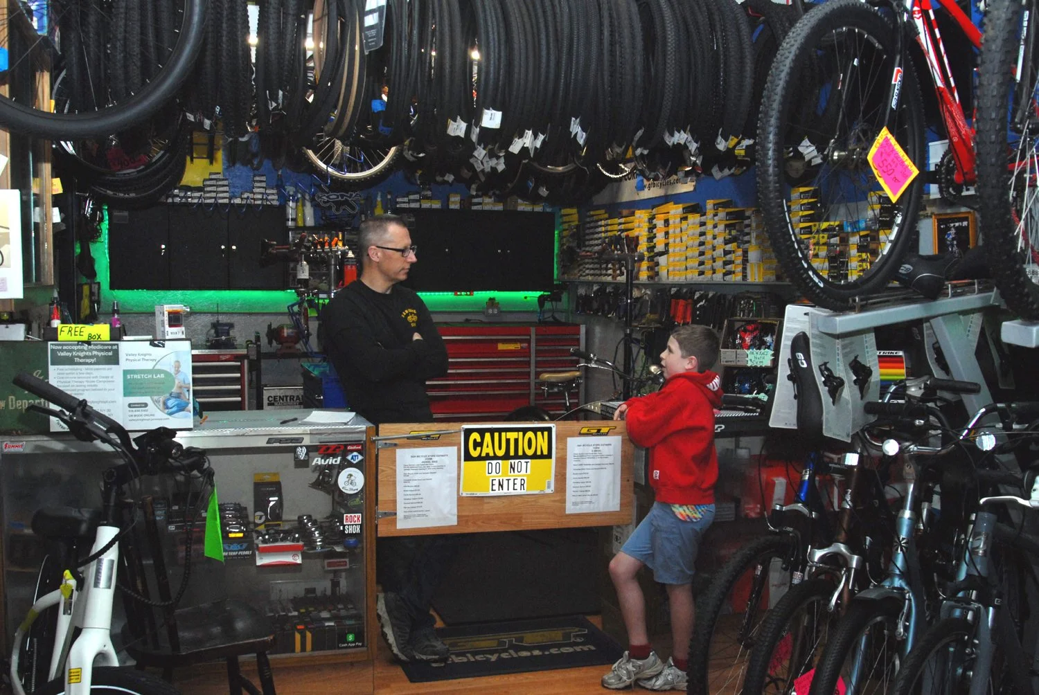 S&H Bikes owner Steve Hickey waits on a young customer.