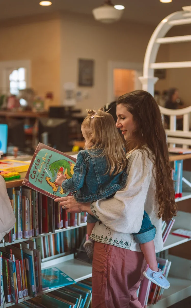 Family at a library in Upstate New York exploring the books