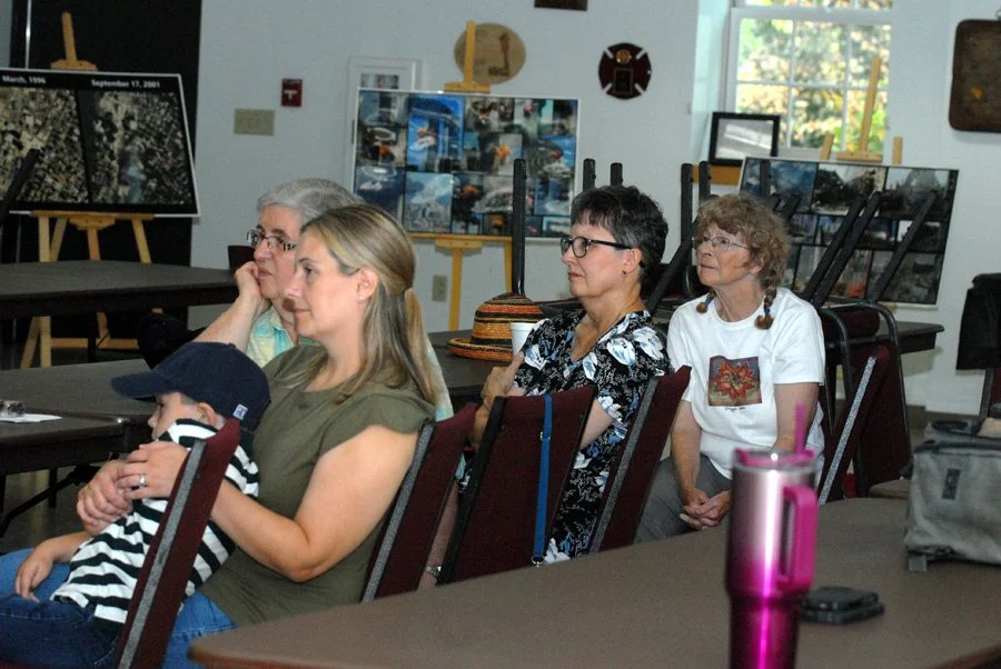 A crowd listens to 9/11 memories from local rescue volunteers.