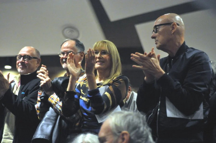 Audience members stand to applaud poet Billy Collins.