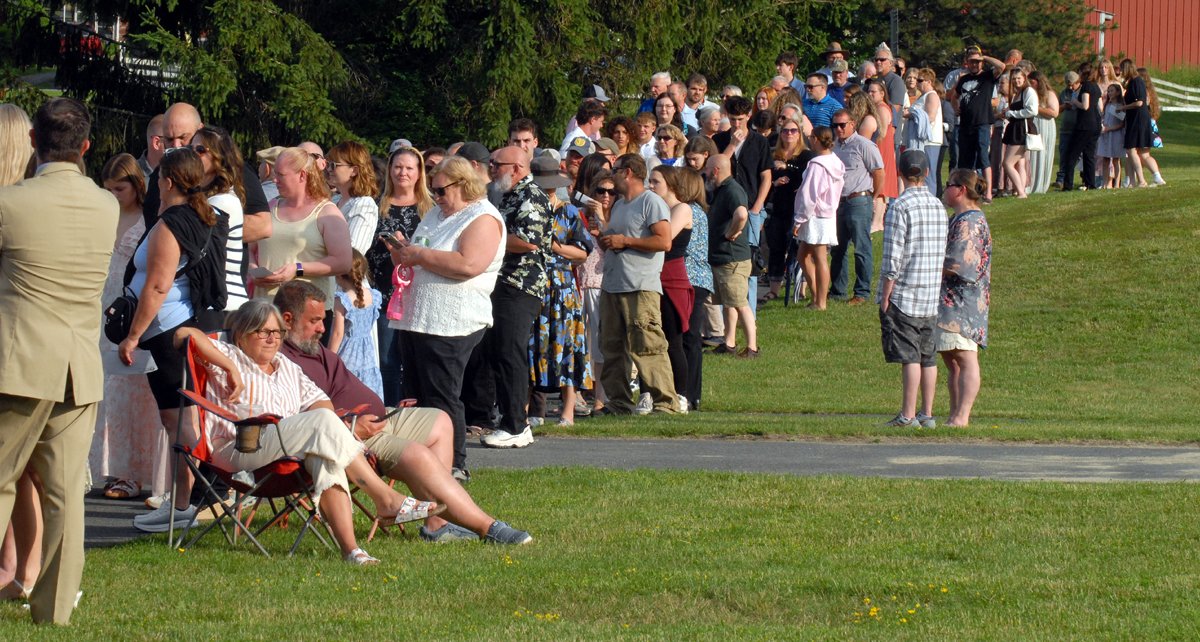 A long line of family and friends waits to be let onto the football field for Cobleskill-Ricmondville's graduation ceremonies.