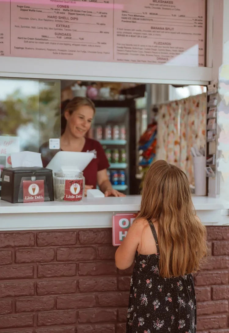 woman at ice cream window with child ordering in schoharie, county, one of the best places to live in upstate new york