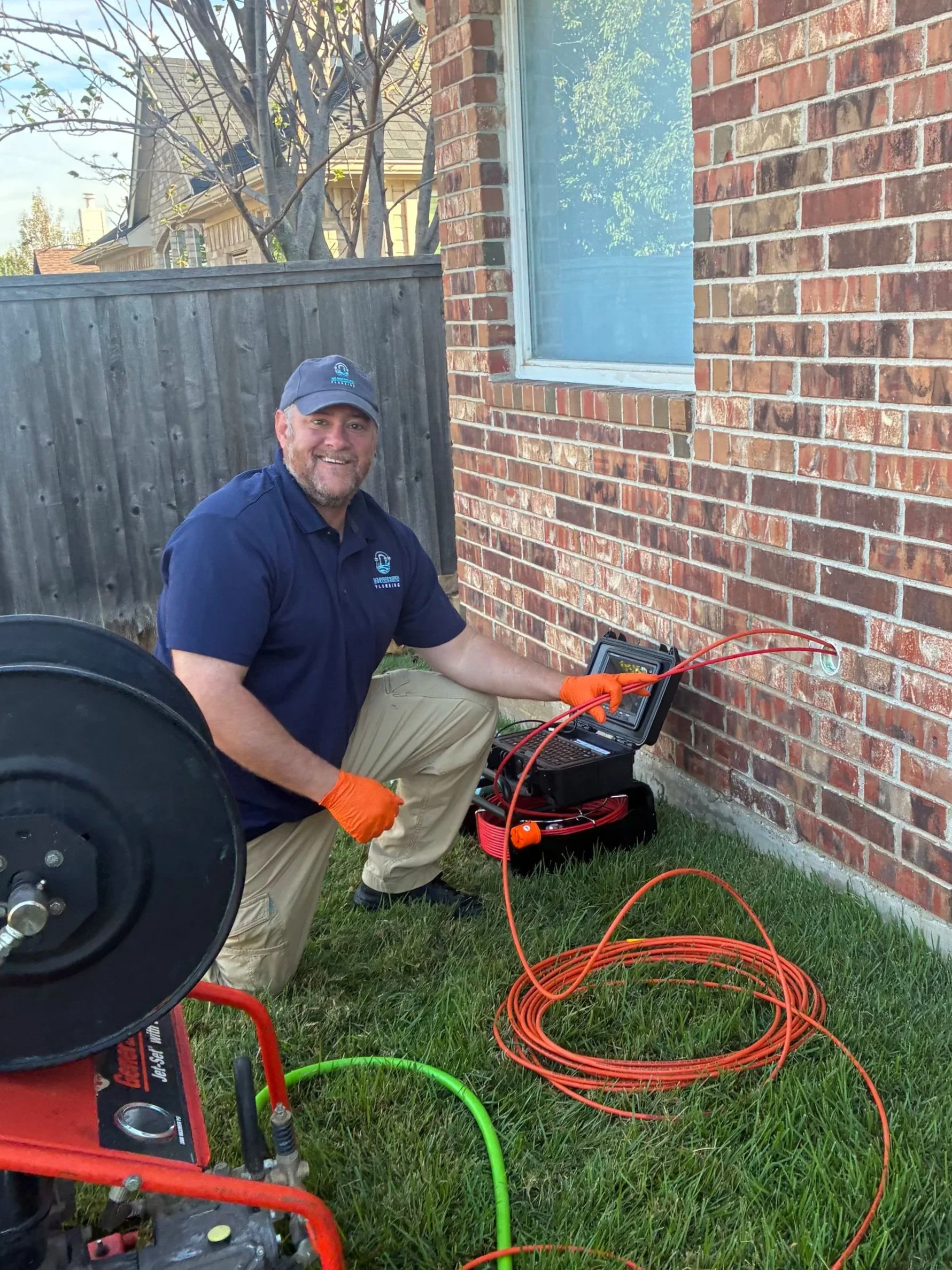 Alt text: Nick Green performing sewer camera inspection at a residential home