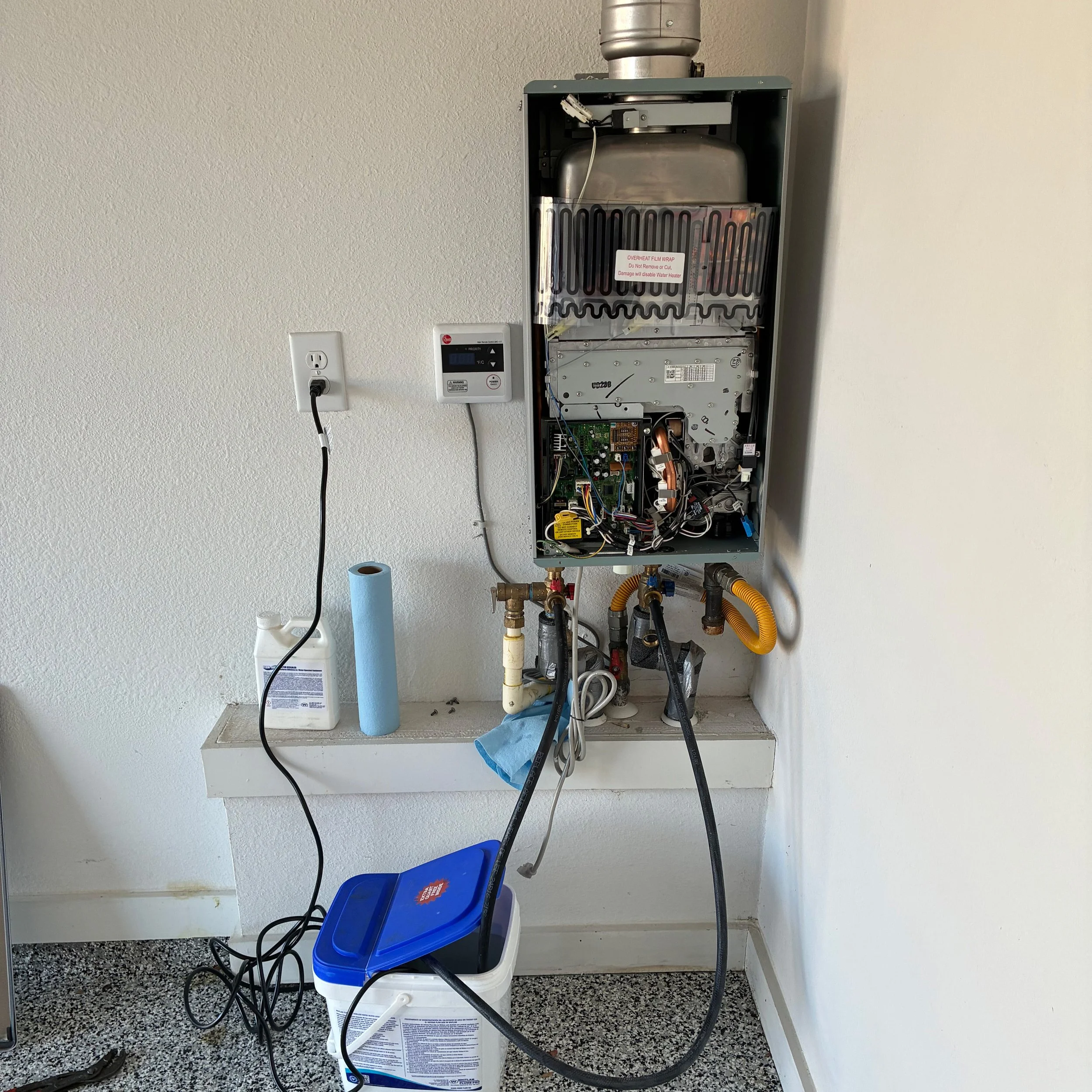 ankless water heater opened for annual descaling and flush service